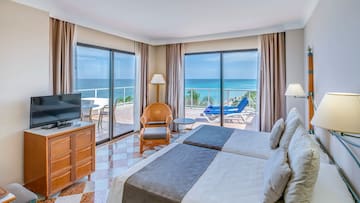 a room with two beds and a television