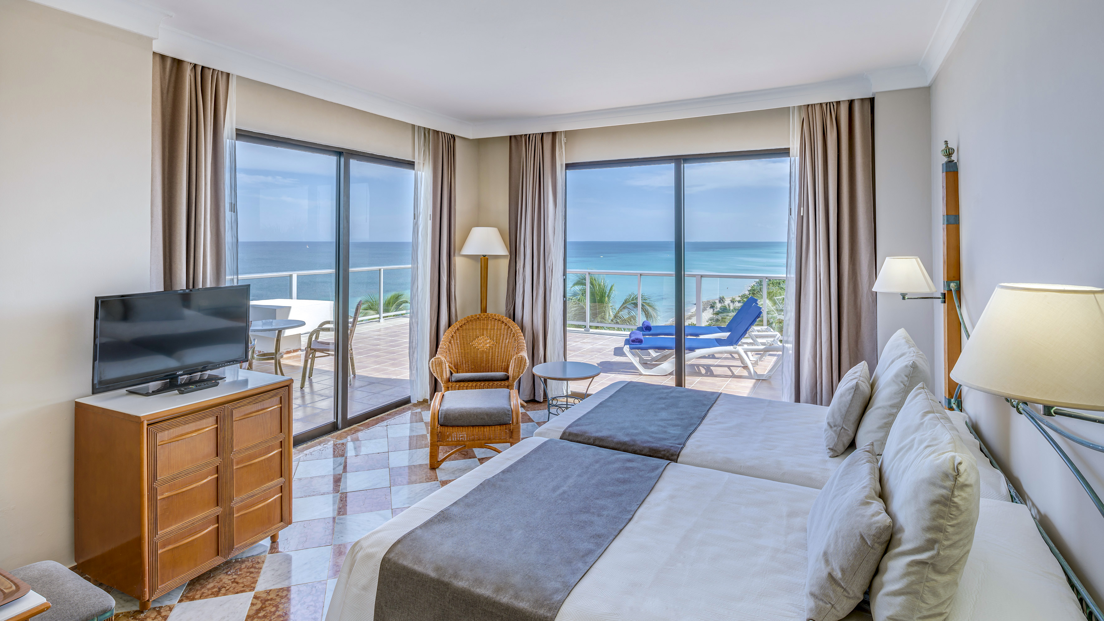 a room with two beds and a television