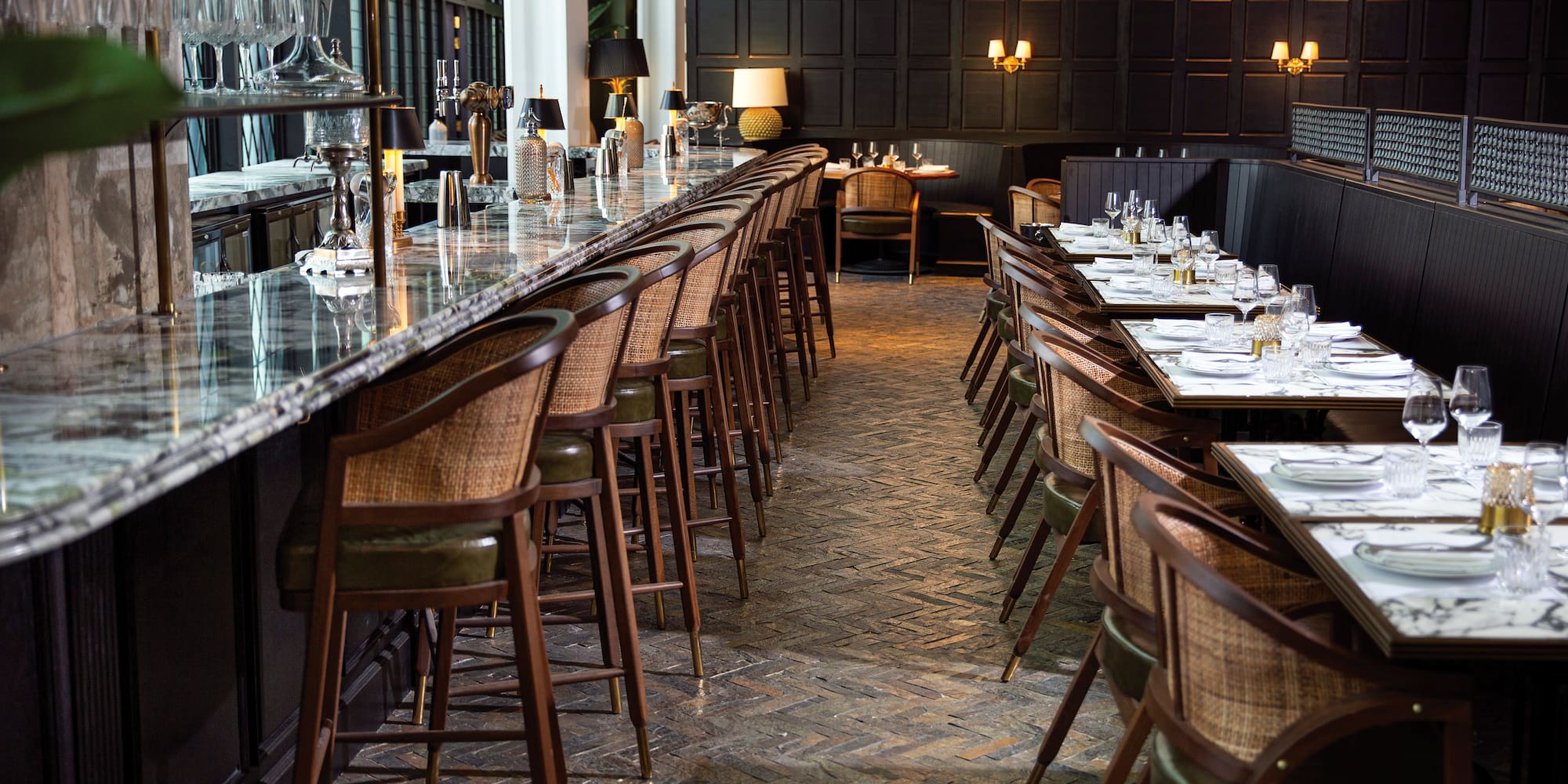 a long table with chairs and glasses on it