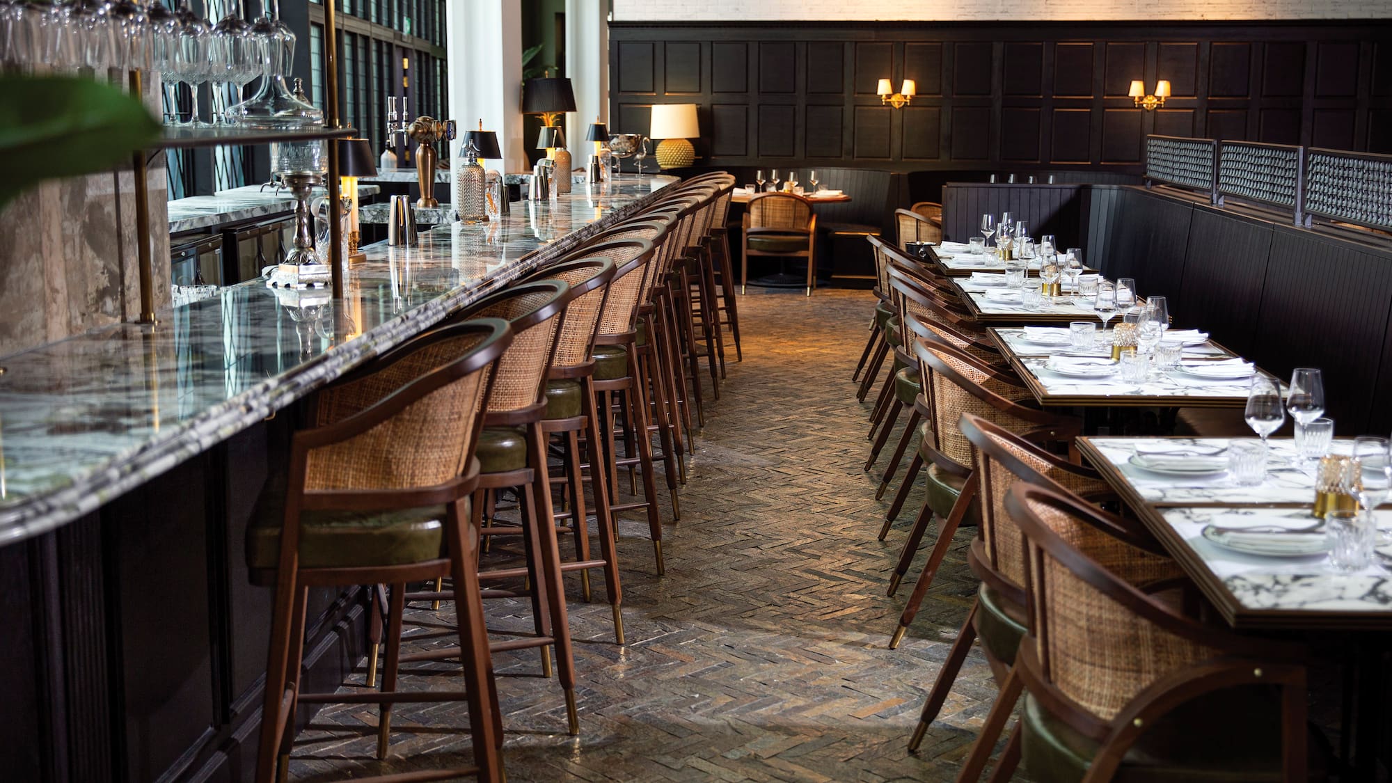 a long table with chairs and glasses on it