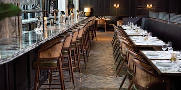 a long table with chairs and glasses on it