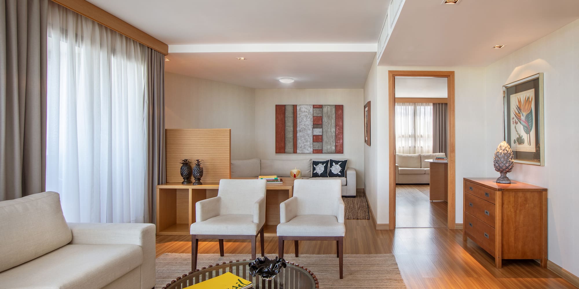 a living room with white furniture and a coffee table