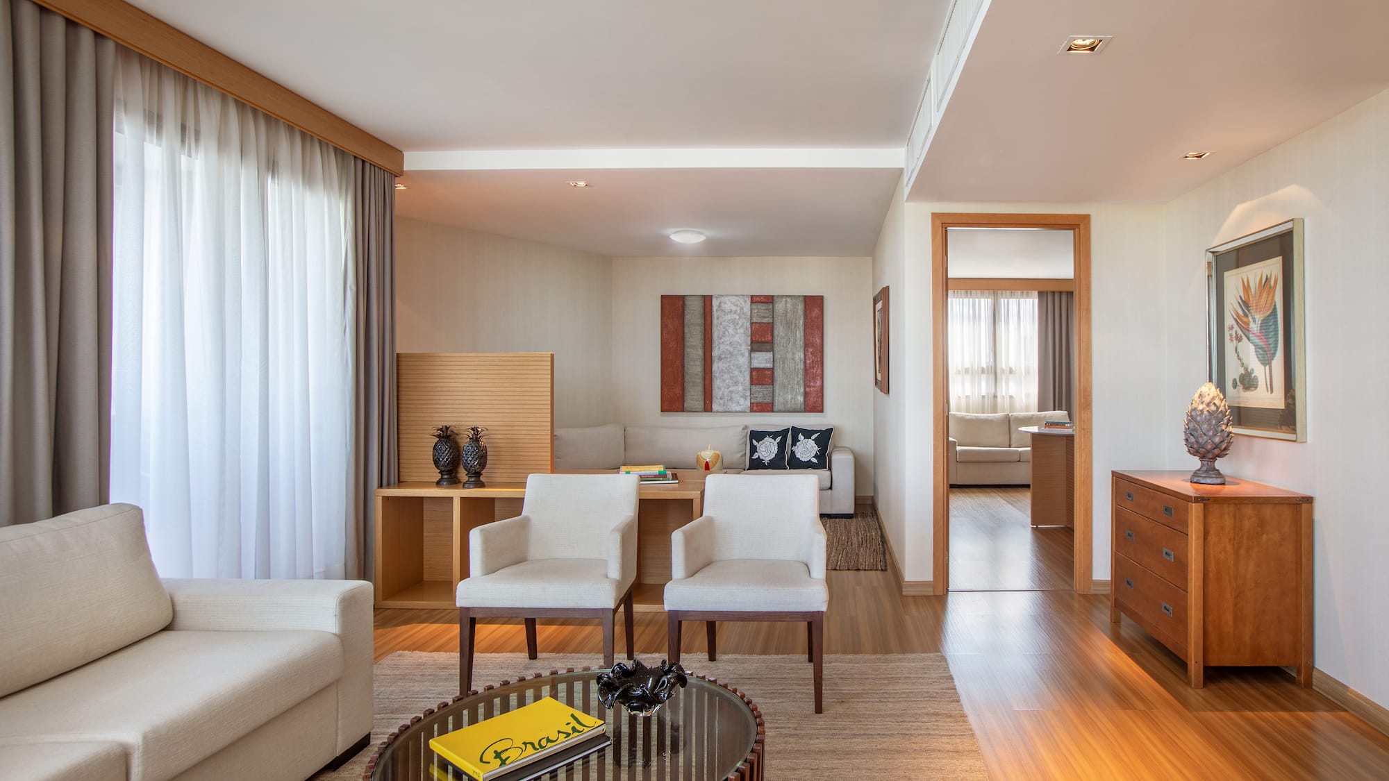 a living room with white furniture and a coffee table