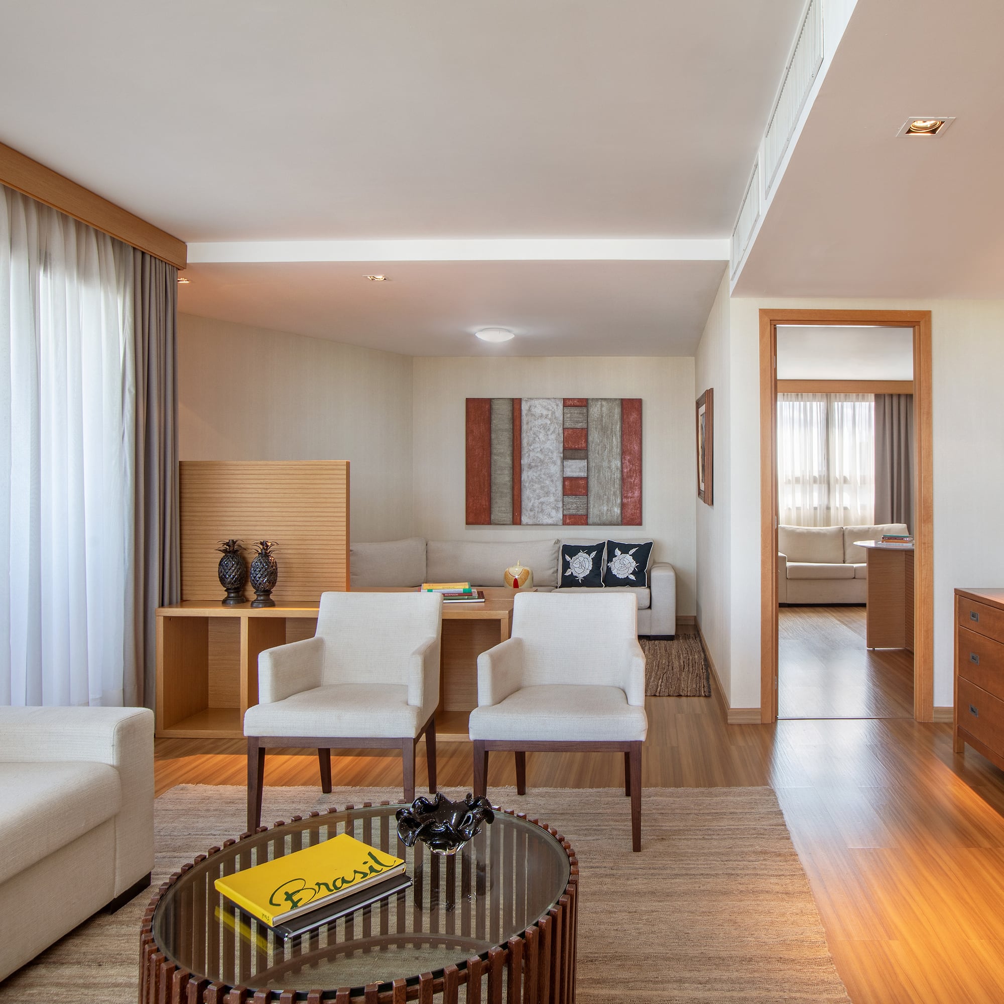 a living room with white furniture and a coffee table
