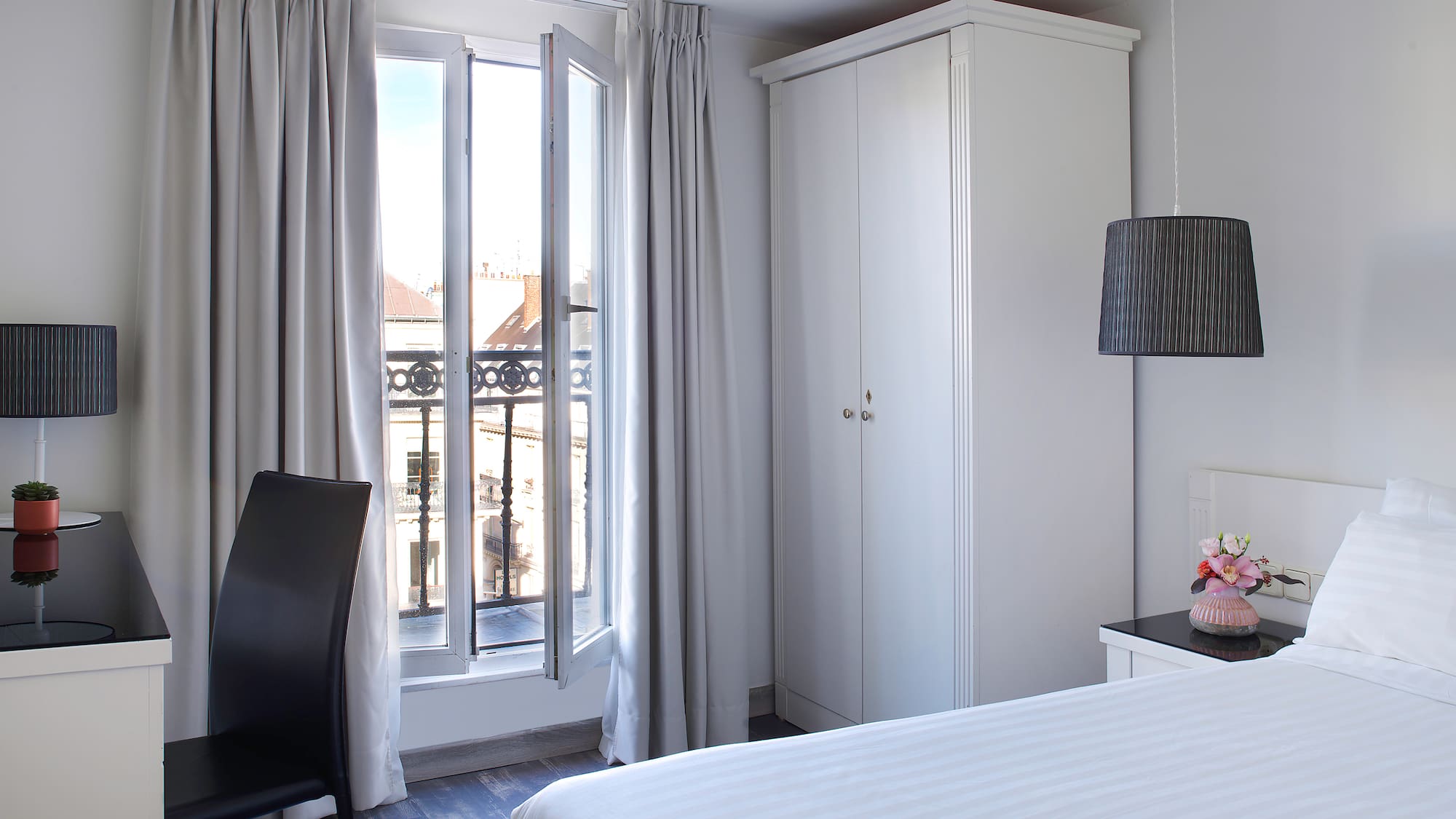 a bedroom with a bed and a chair