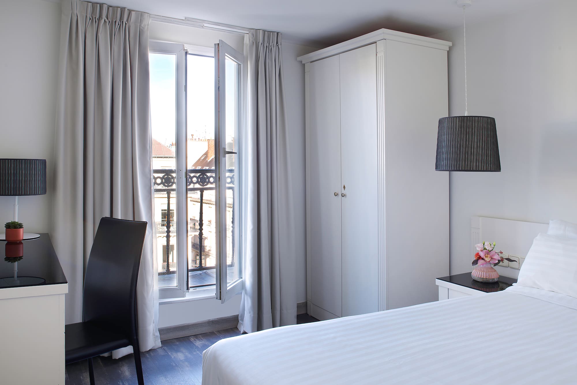 a bedroom with a bed and a chair