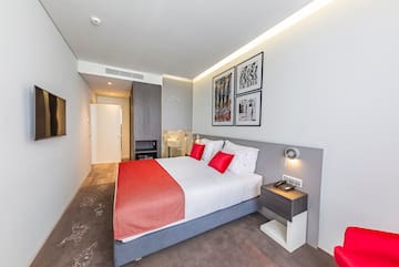 a bed with red and white pillows