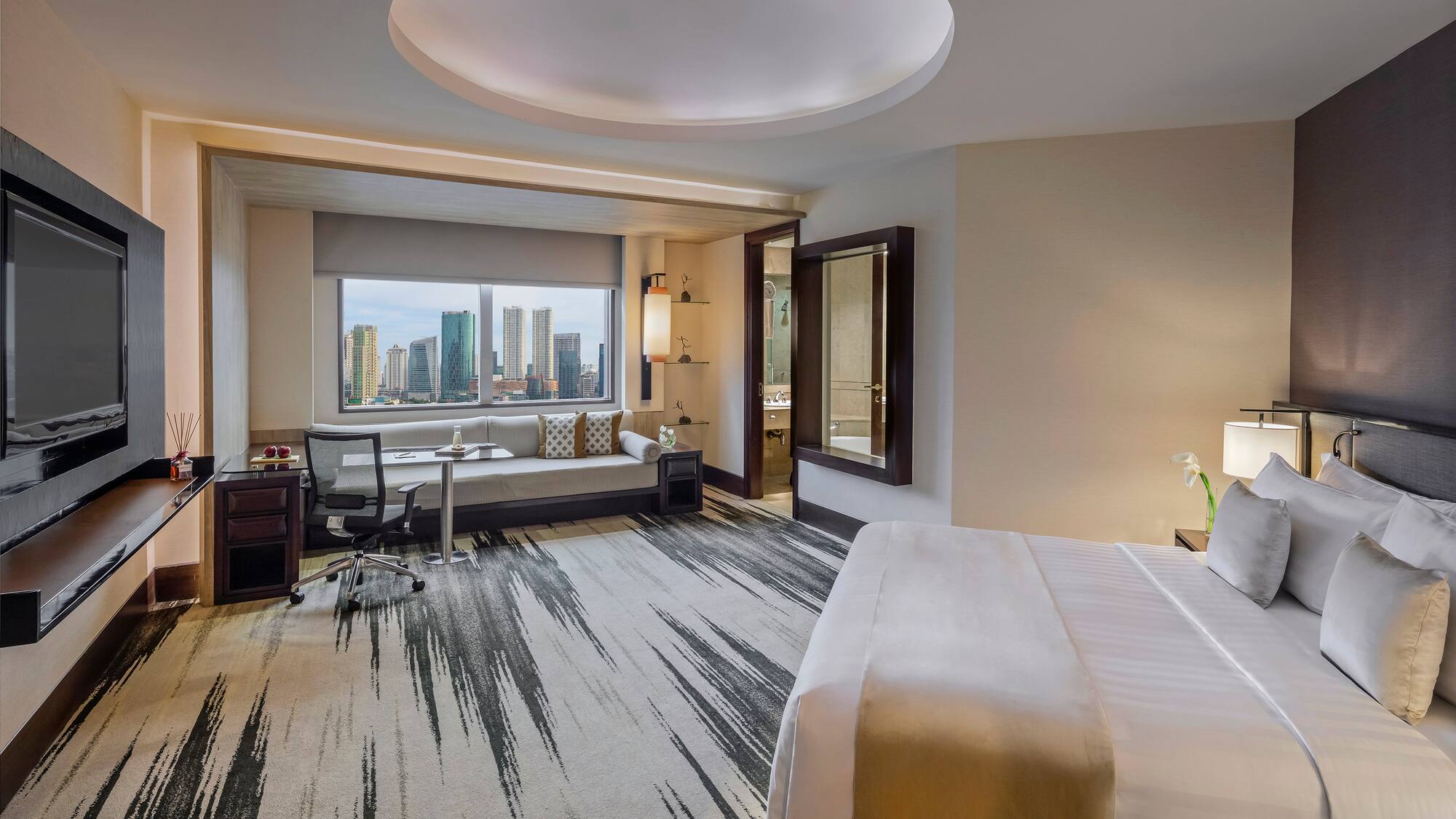 a room with a bed and a desk and chair