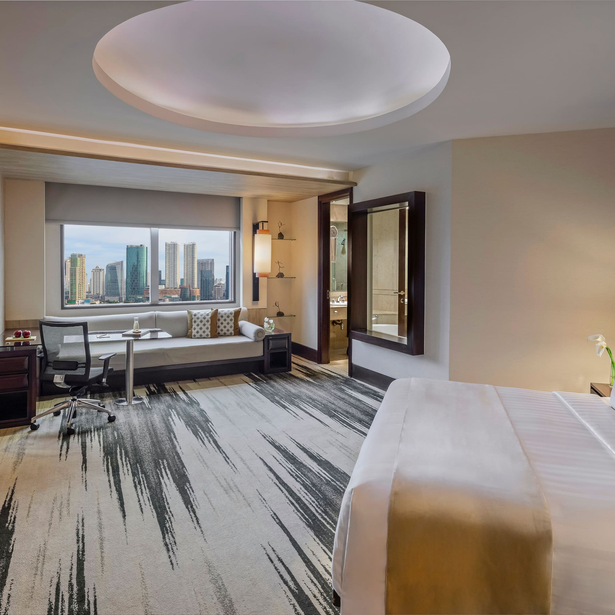 a room with a bed and a desk and chair