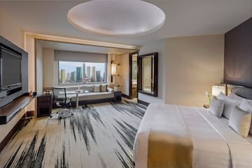 a room with a bed and a desk and chair