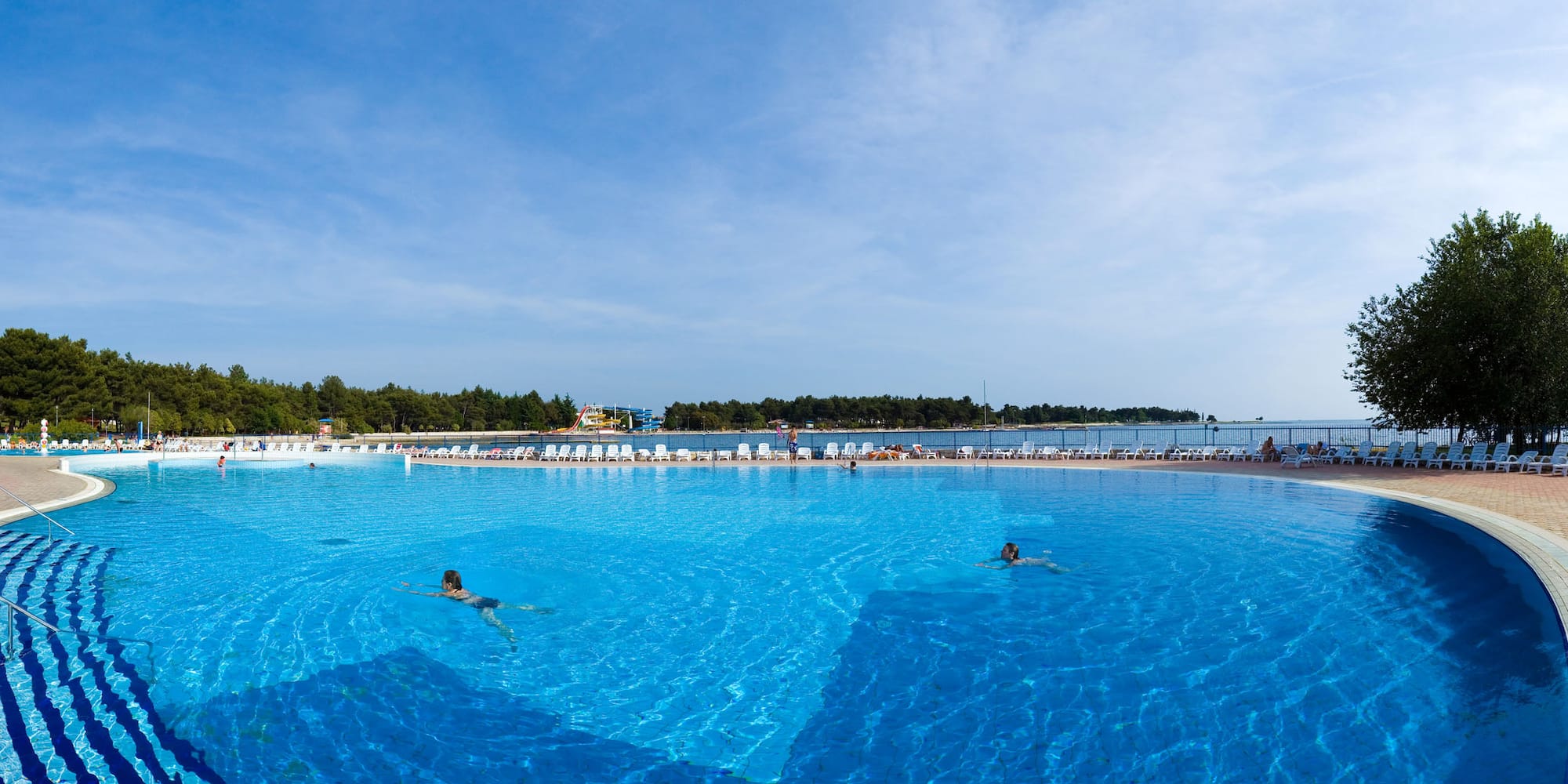 people swimming in a large pool
