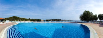 people swimming in a large pool