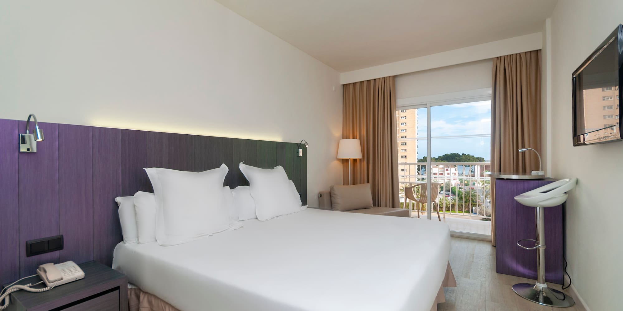 a room with a bed and a balcony