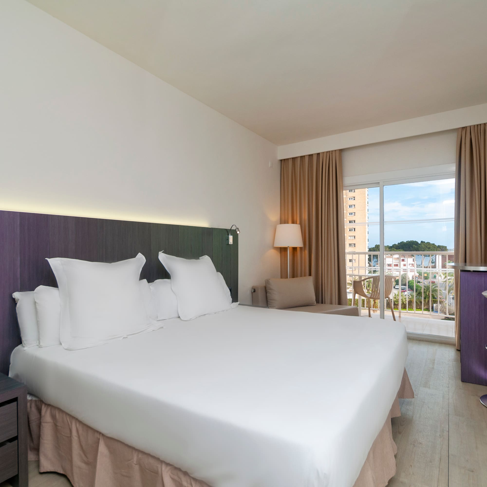 a room with a bed and a balcony