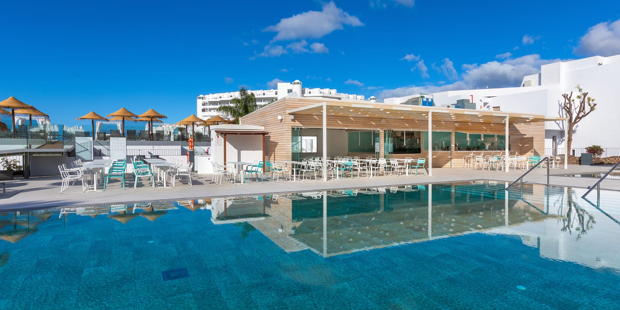 a pool with a building and a roof