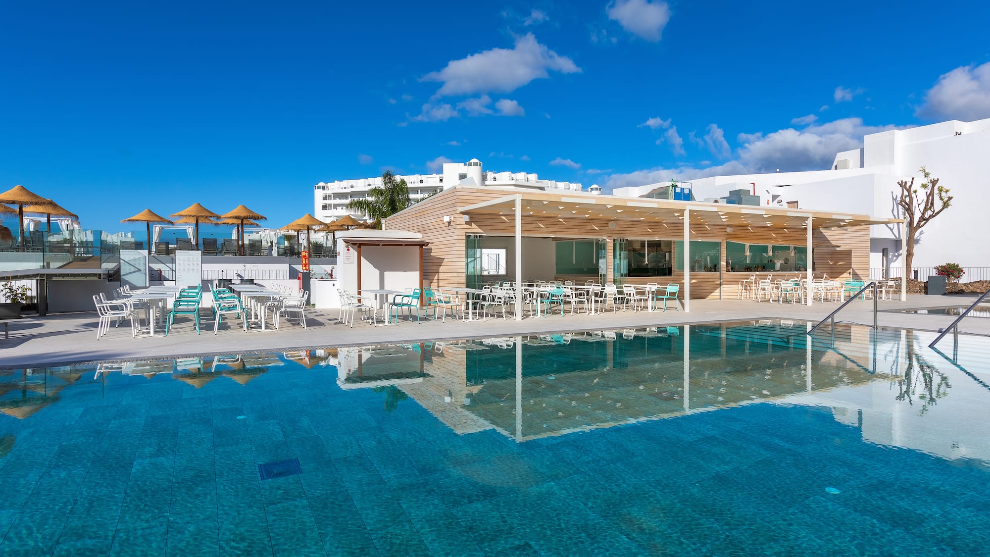 a pool with a building and a roof