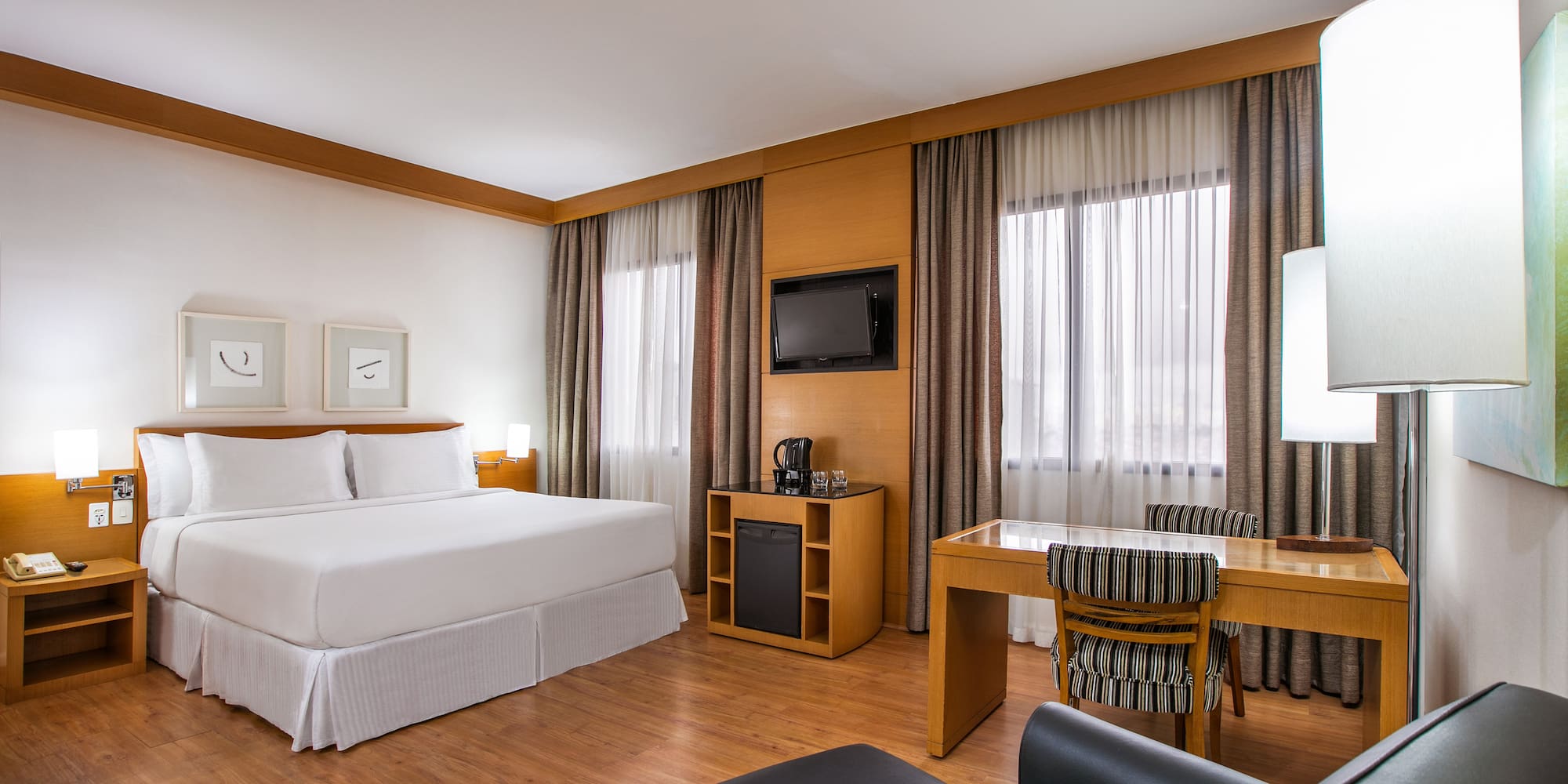 a room with a bed and a table and chairs