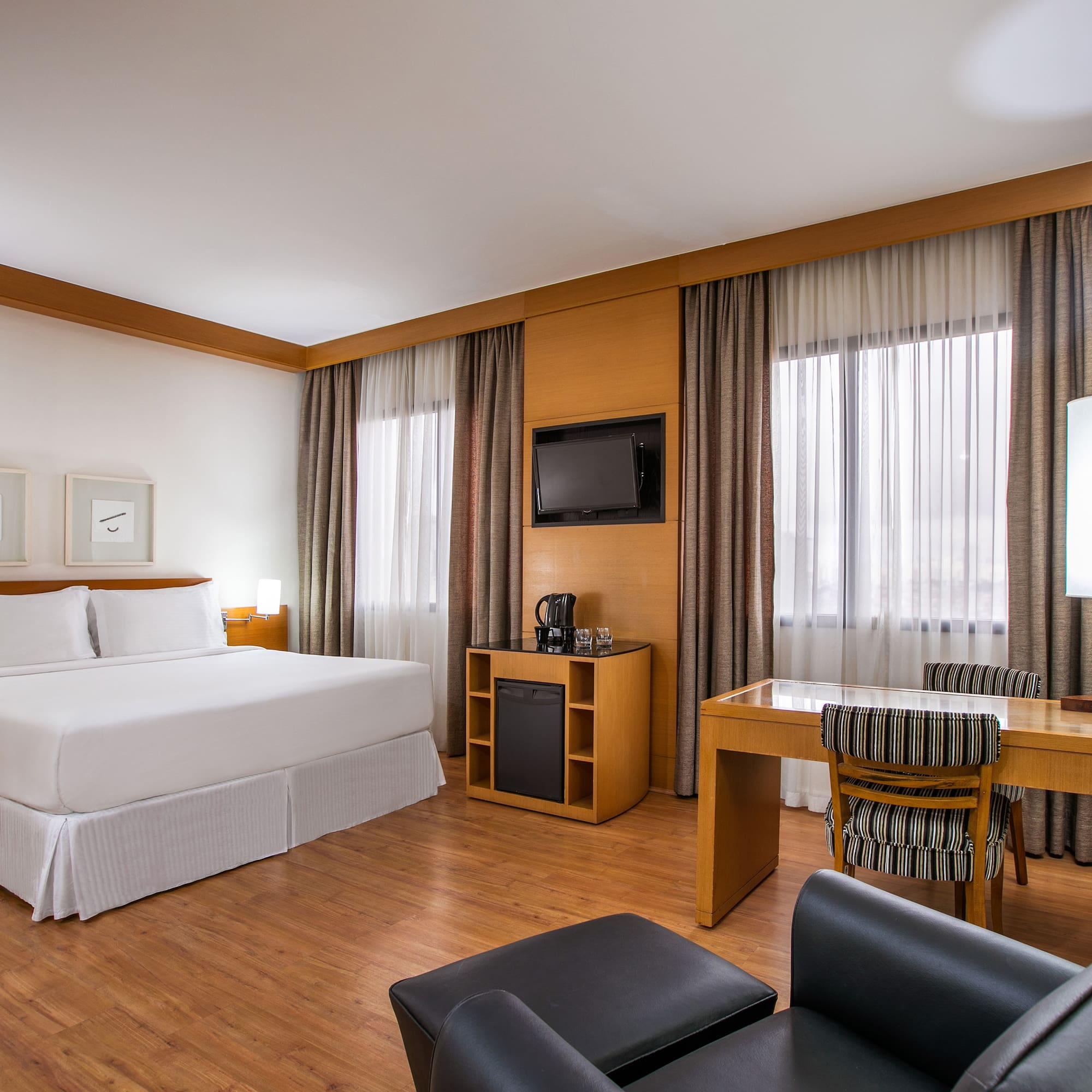 a room with a bed and a table and chairs