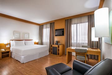 a room with a bed and a table and chairs