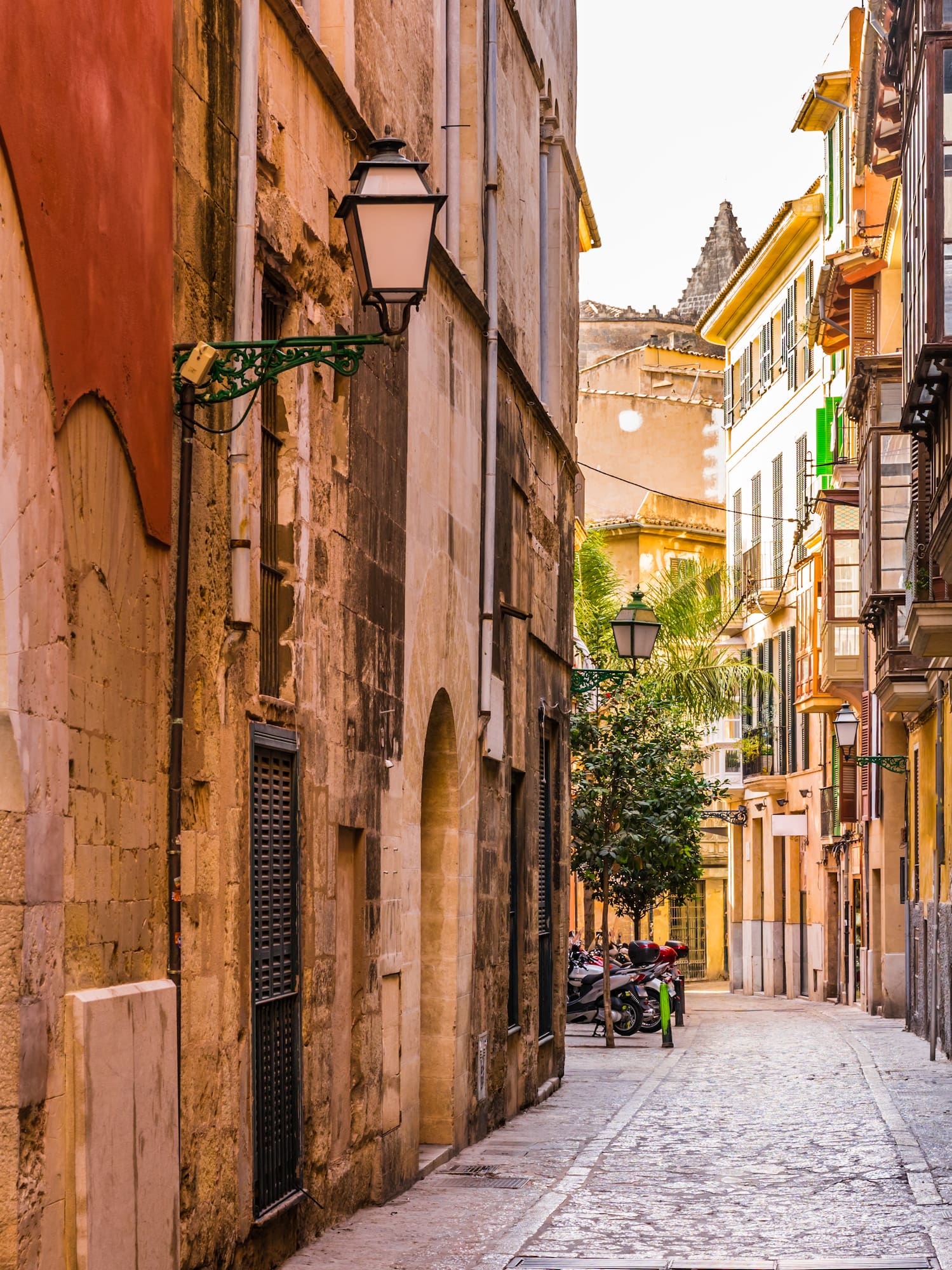 a narrow street with buildings and a bike on the side