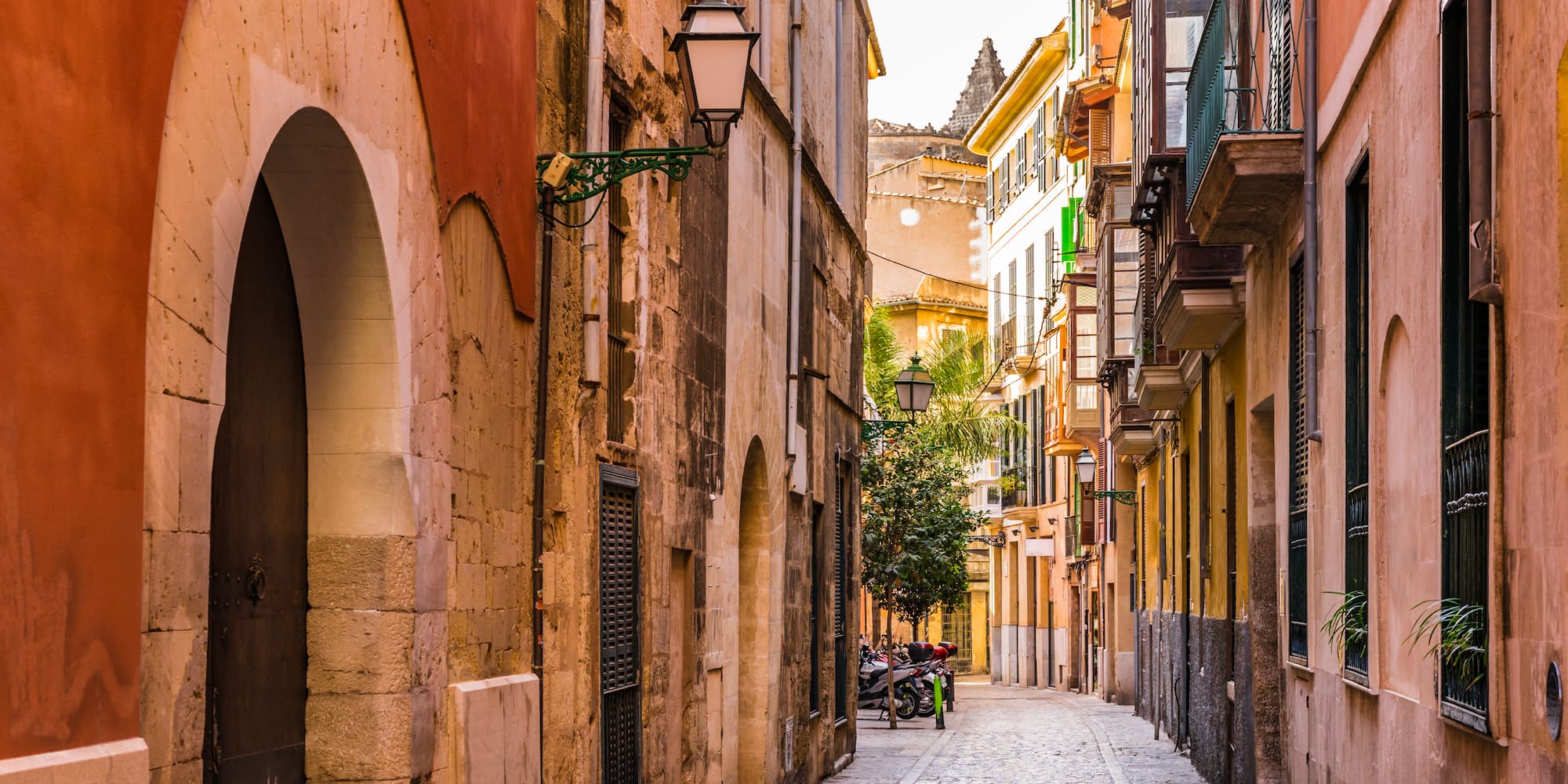a narrow street with buildings and a bike on the side