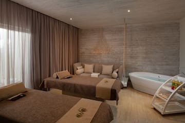 a room with two beds and a bathtub