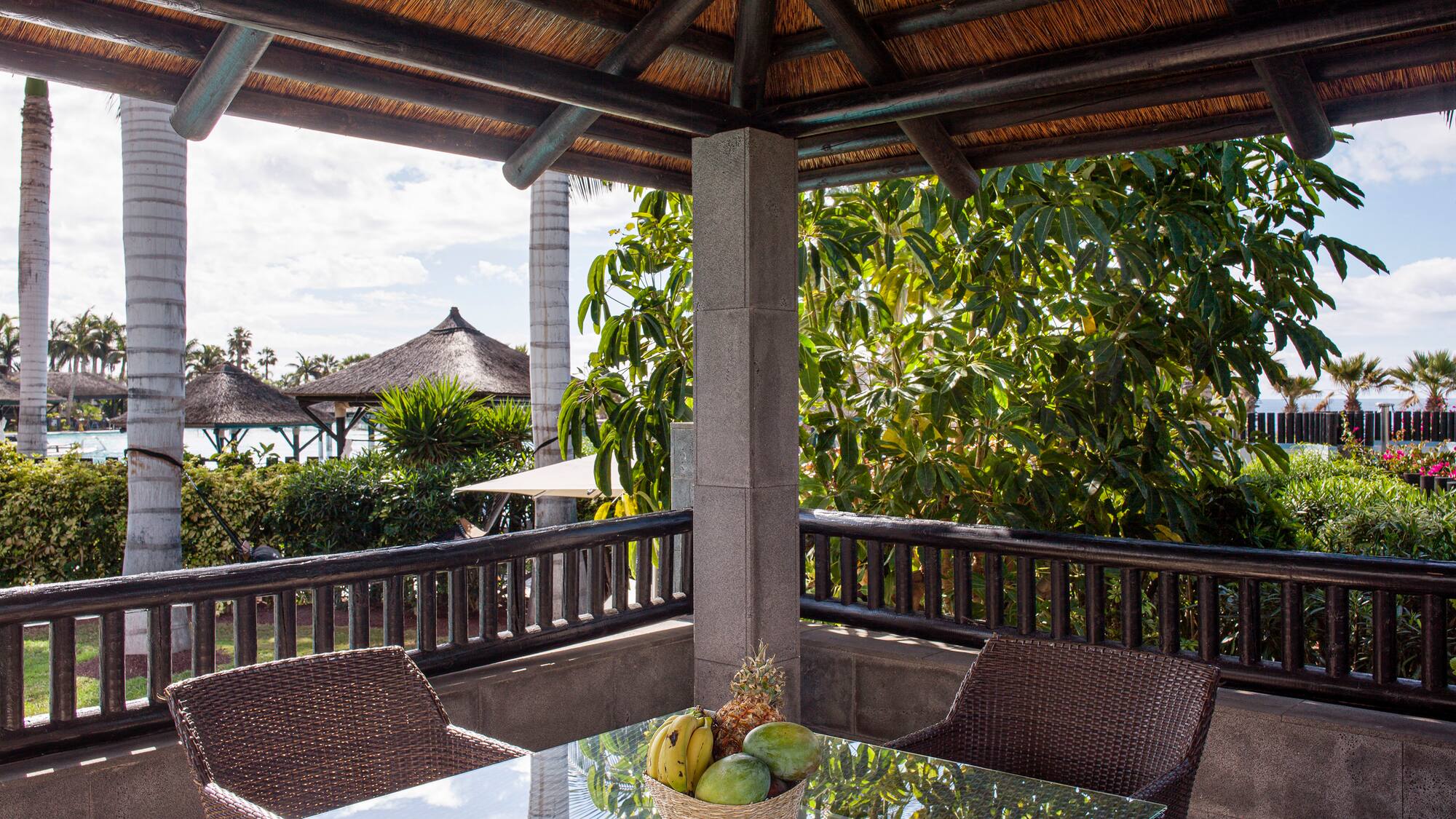 a table and chairs under a roof