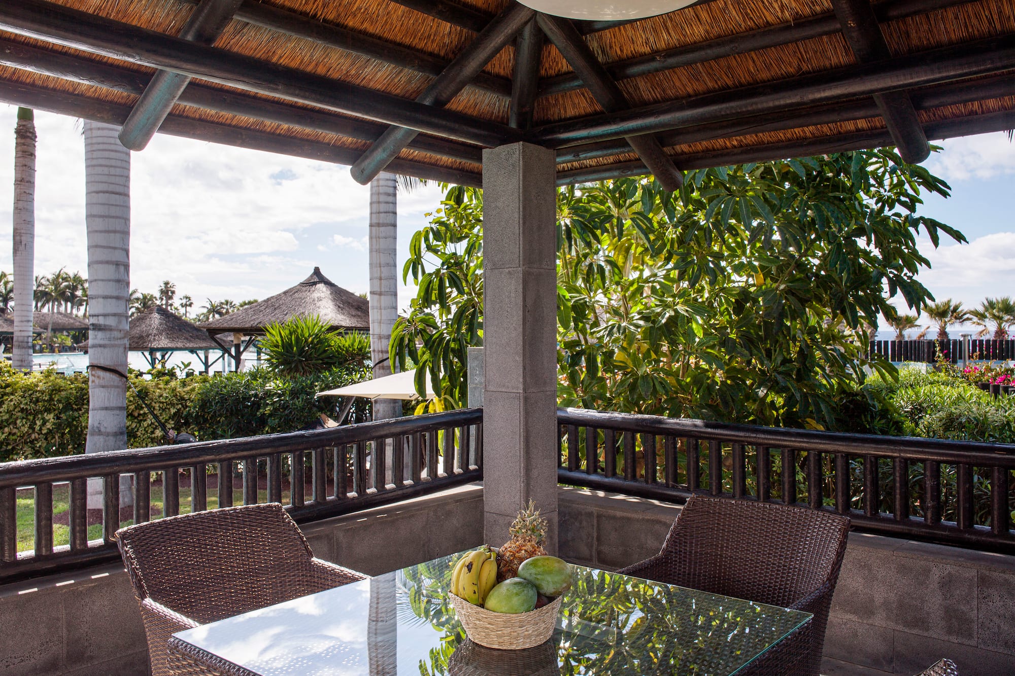 a table and chairs under a roof