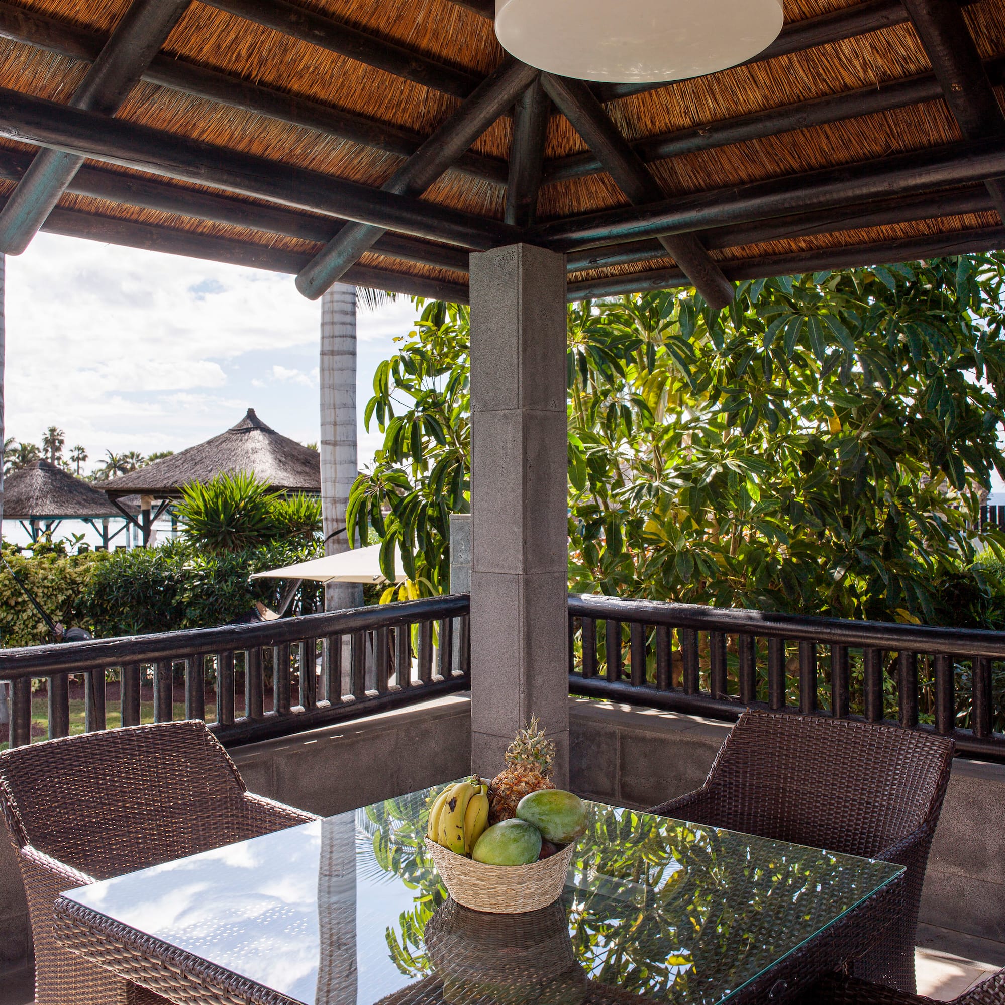 a table and chairs under a roof