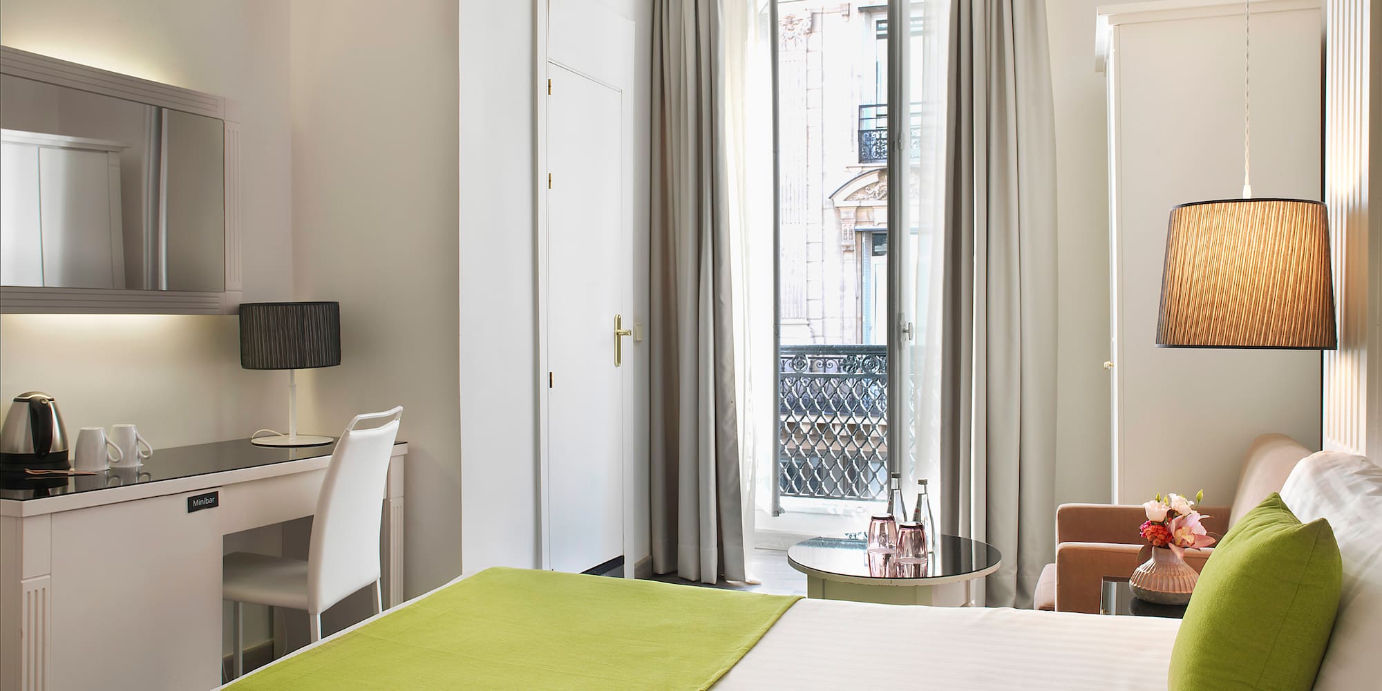 a room with two beds and a desk