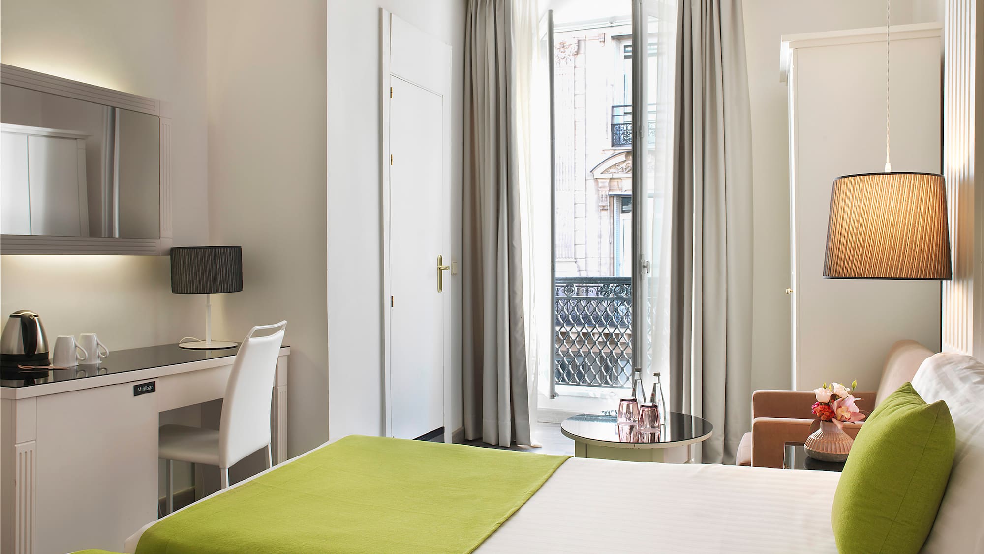 a room with two beds and a desk