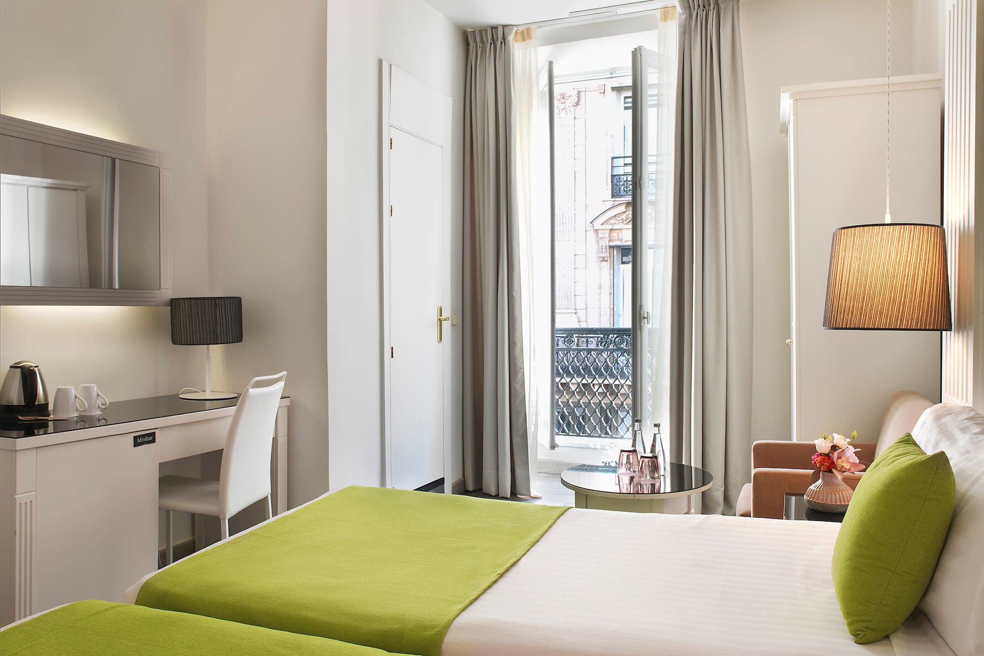 a room with two beds and a desk