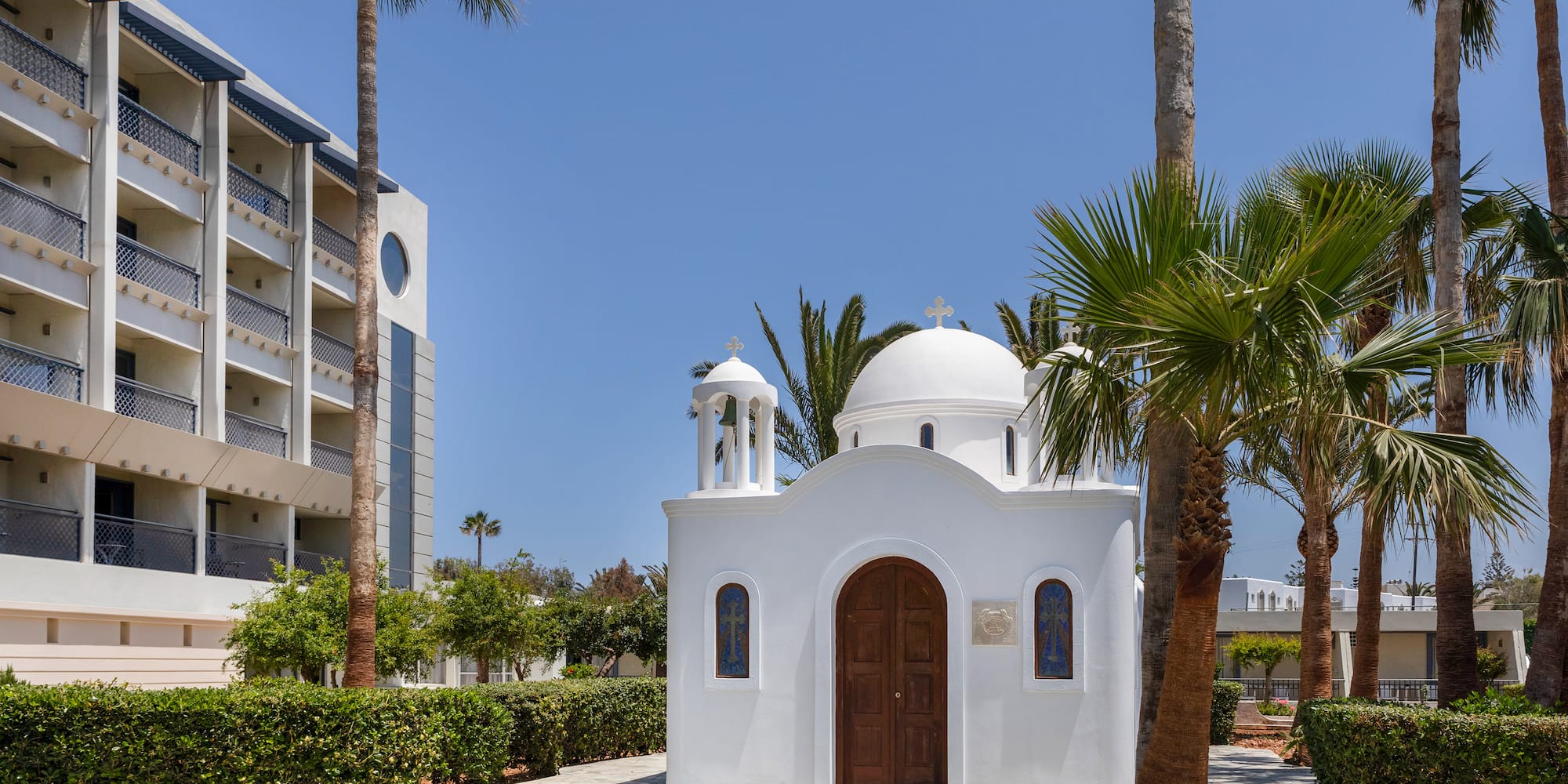 a white building with a dome and a bell tower