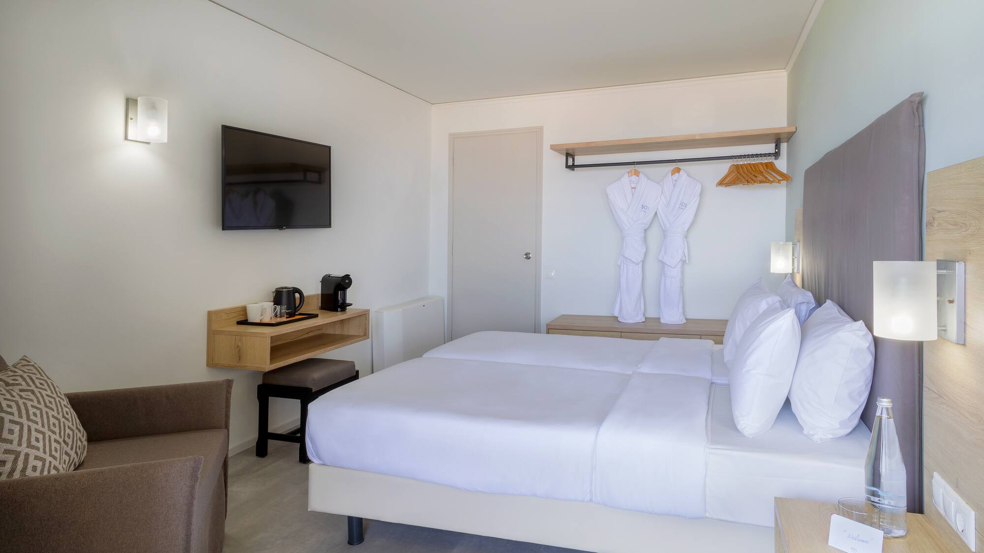 a room with a bed and a television