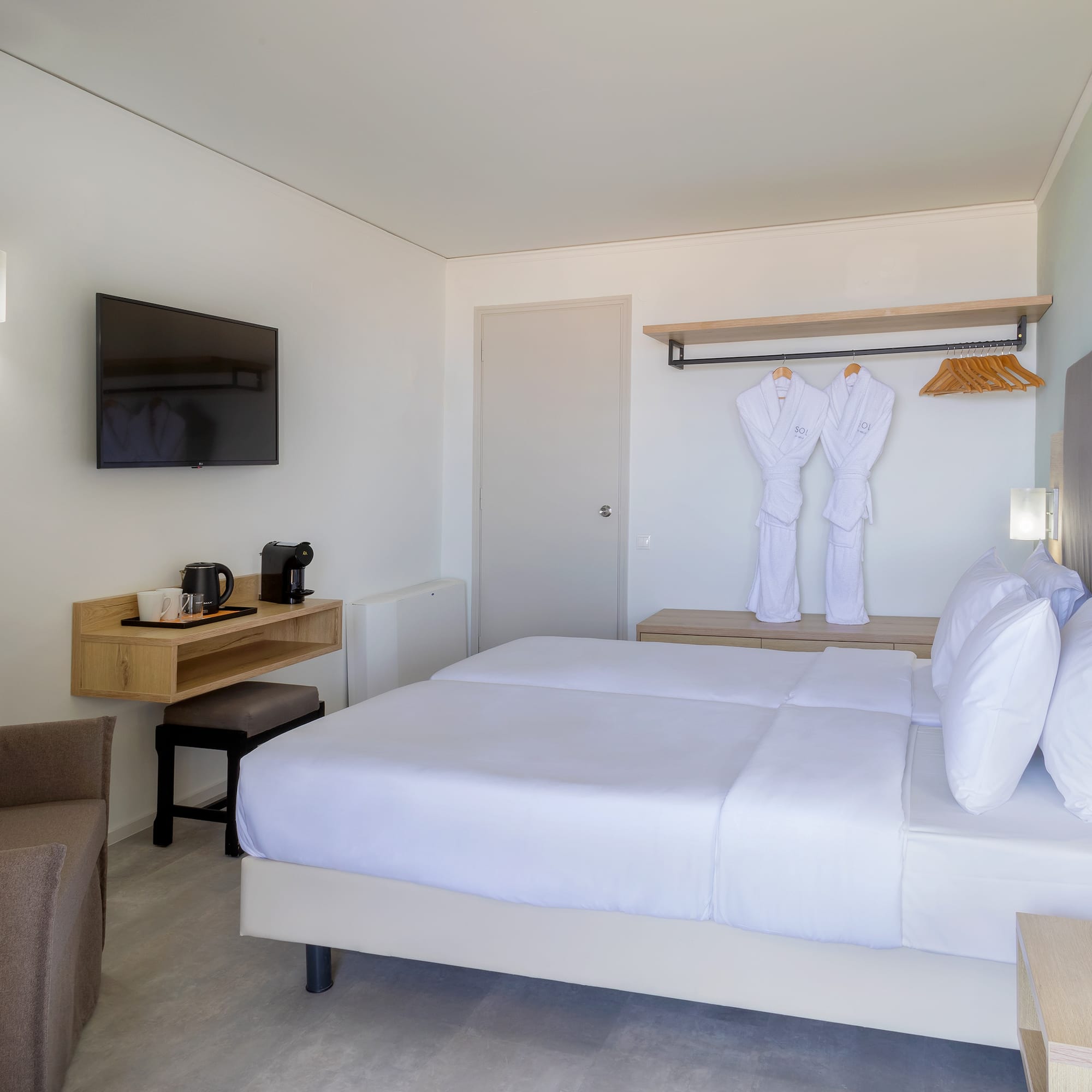 a room with a bed and a television