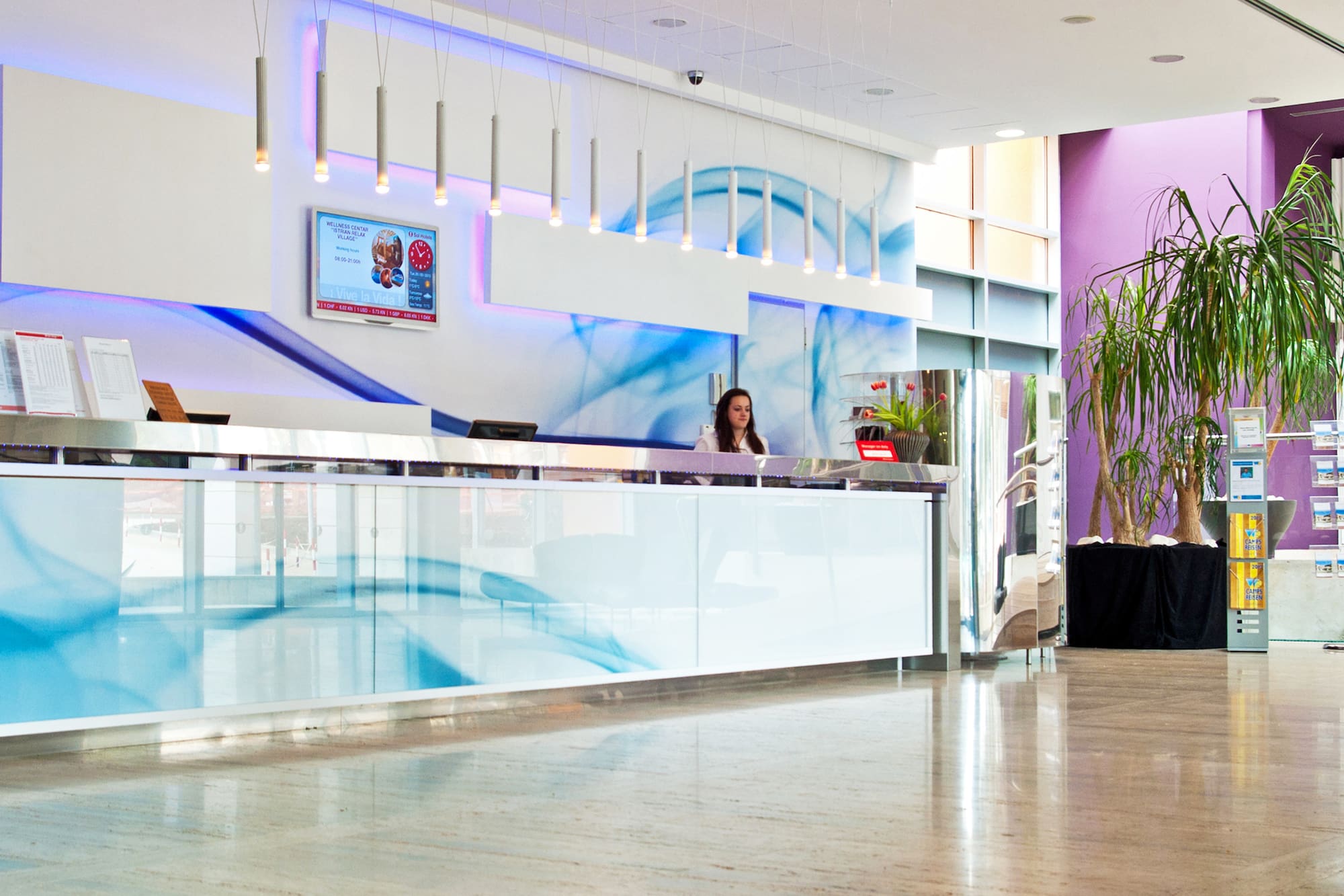 a woman standing at a reception desk
