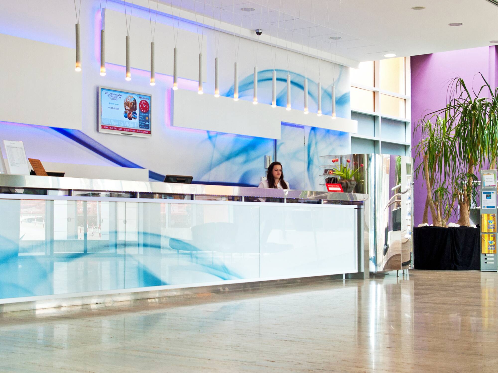 a woman standing at a reception desk