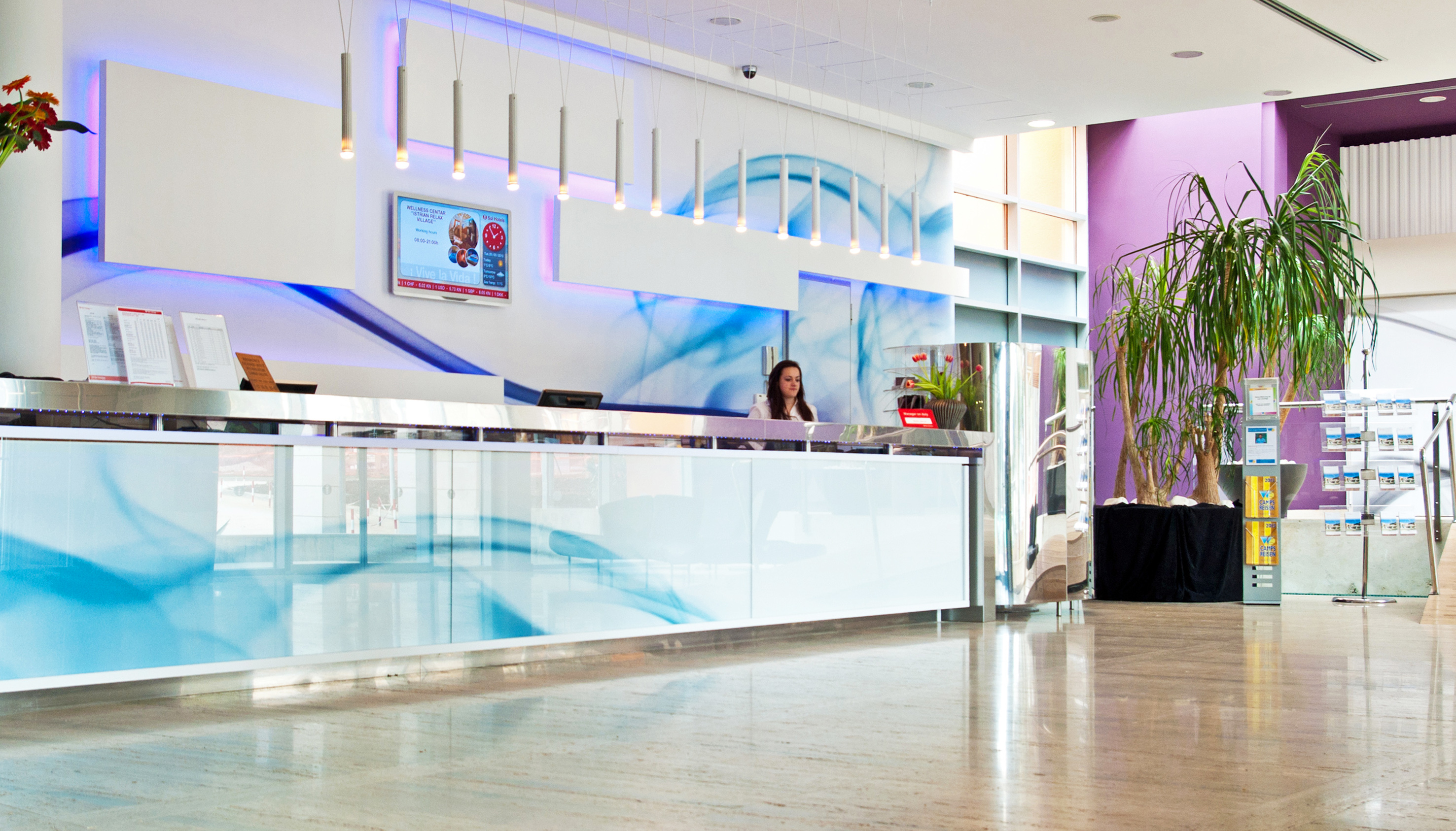 a woman standing at a reception desk