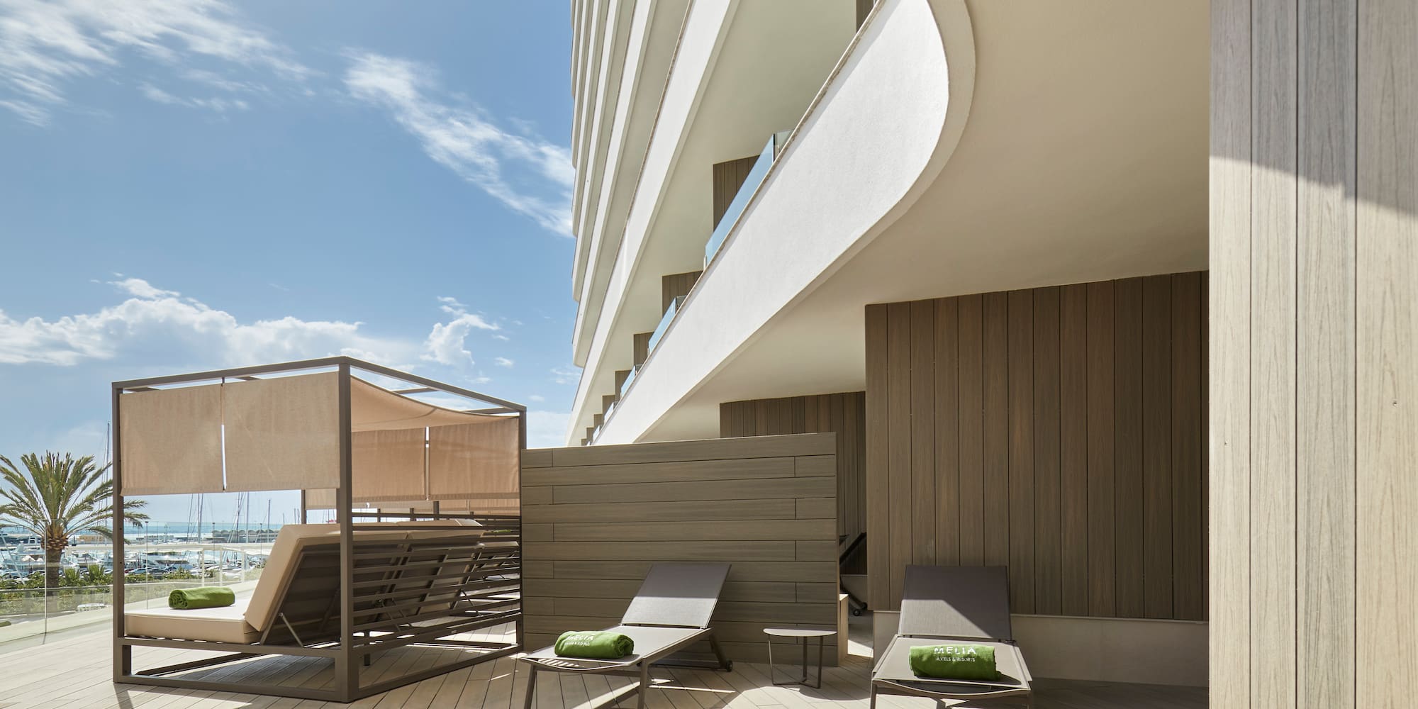 a deck with chairs and a large building