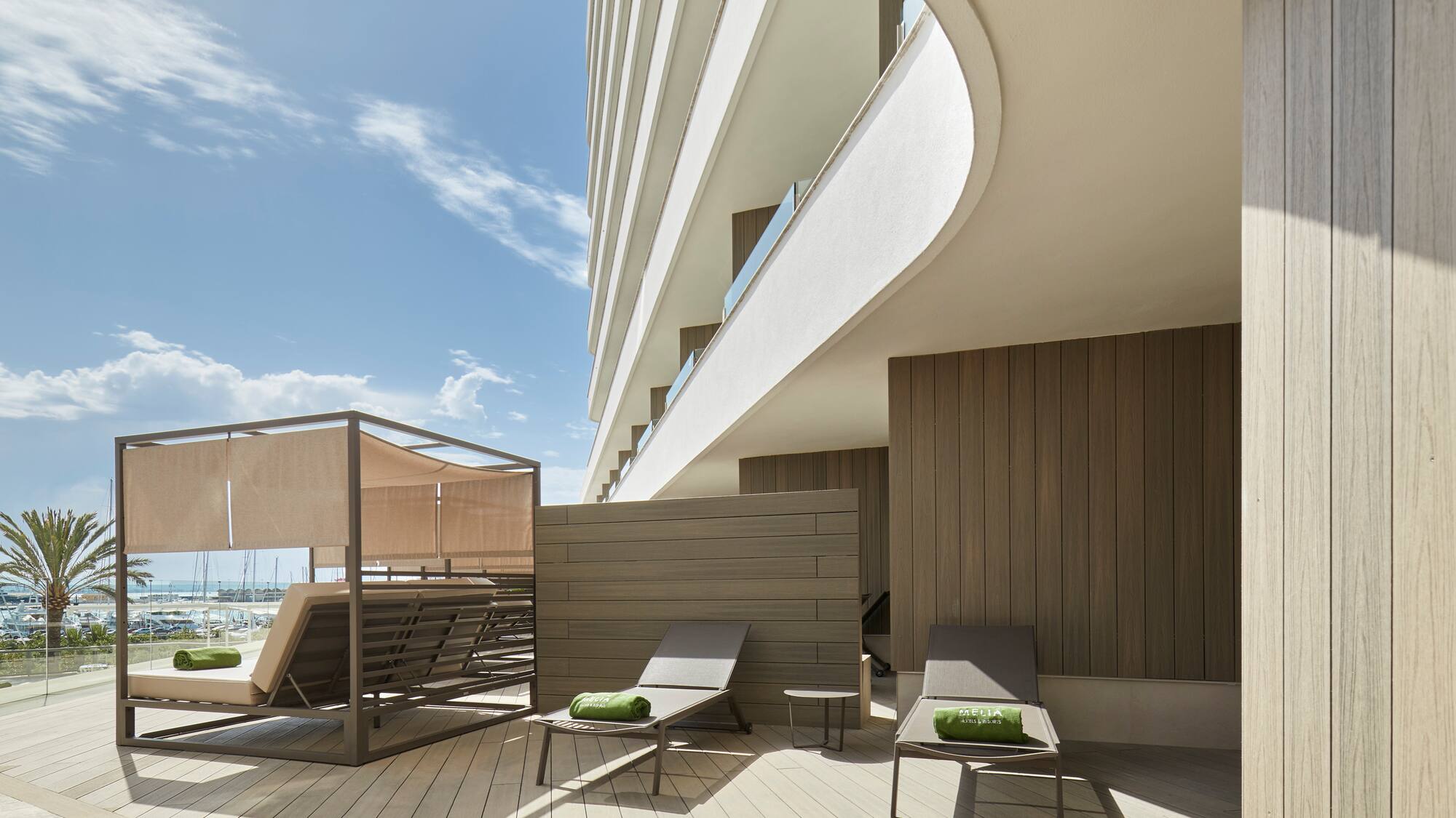 a deck with chairs and a large building