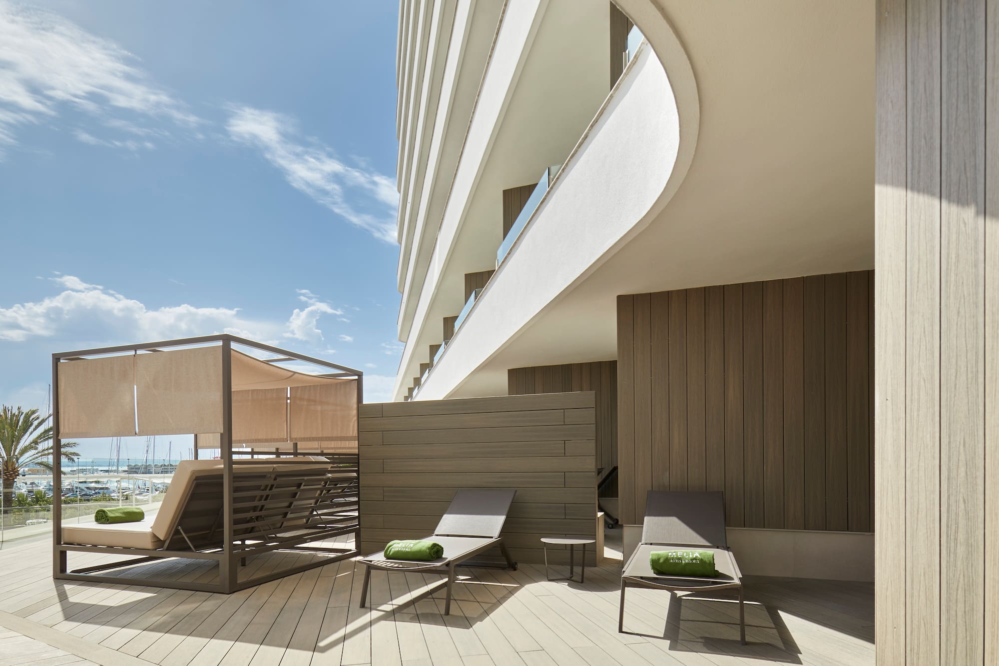 a deck with chairs and a large building