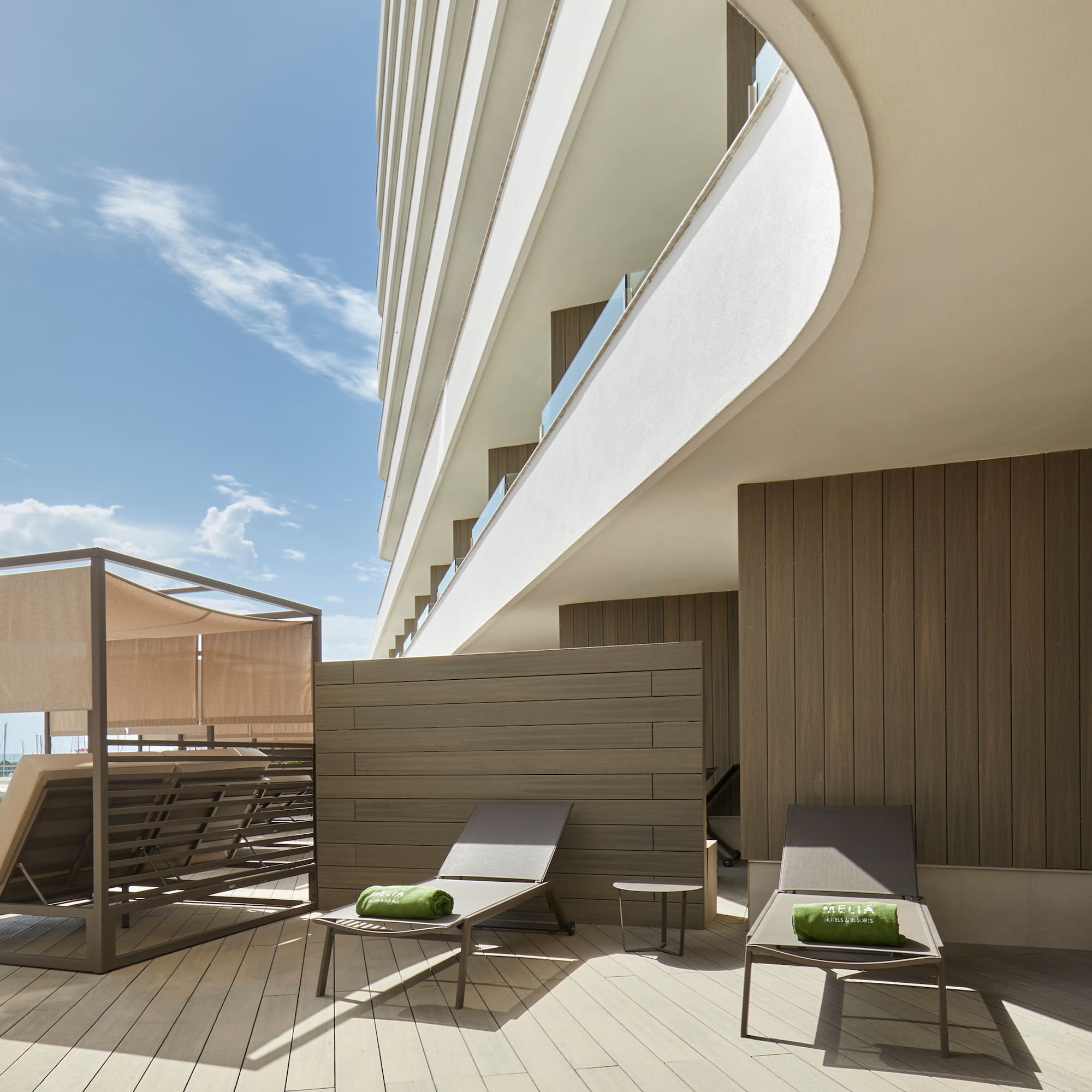 a deck with chairs and a large building