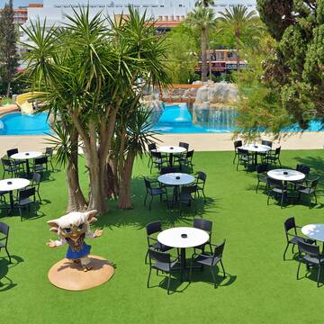 a group of tables and chairs in a park