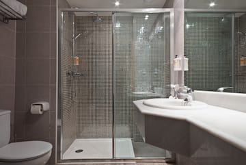 a bathroom with a shower and sink