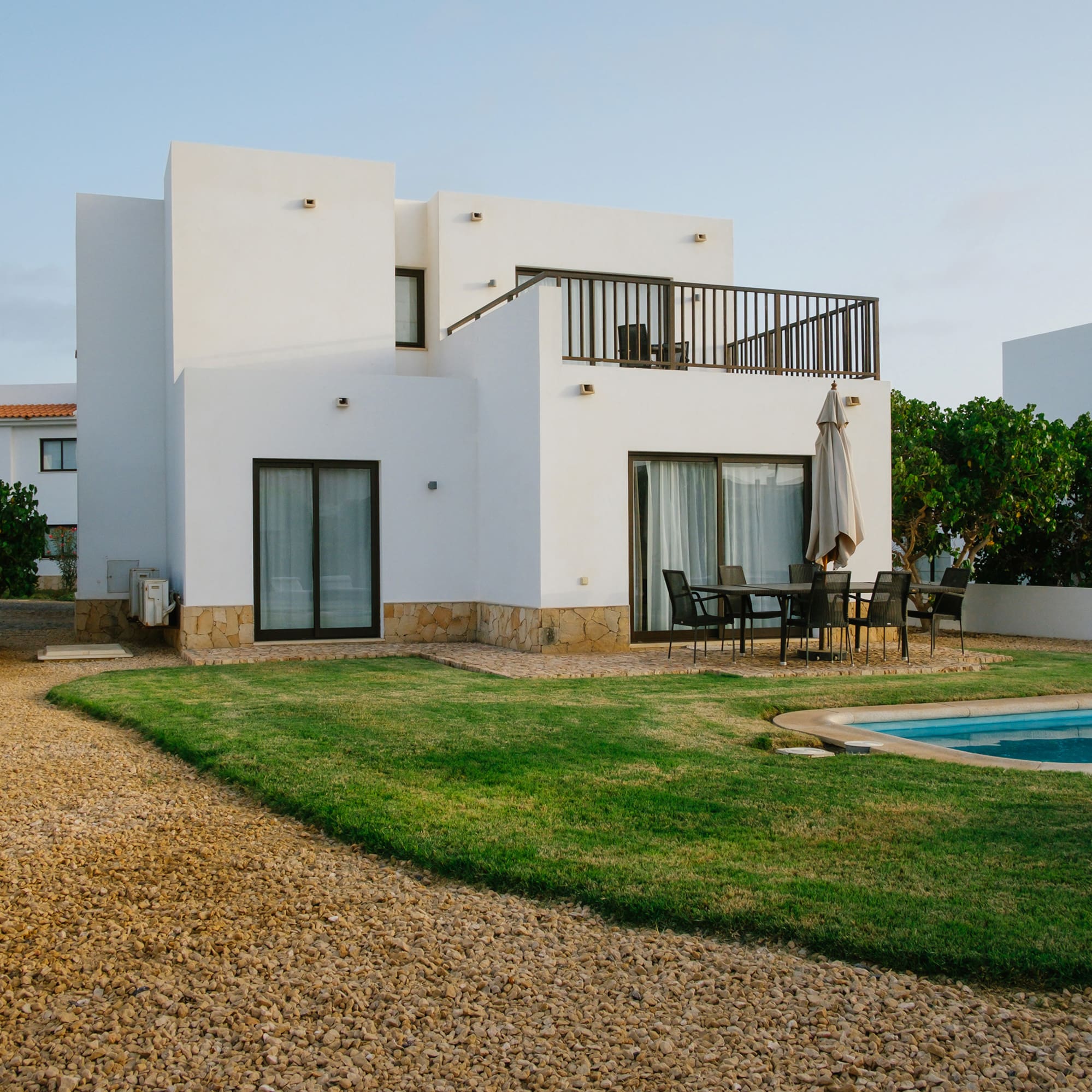 a house with a pool and grass
