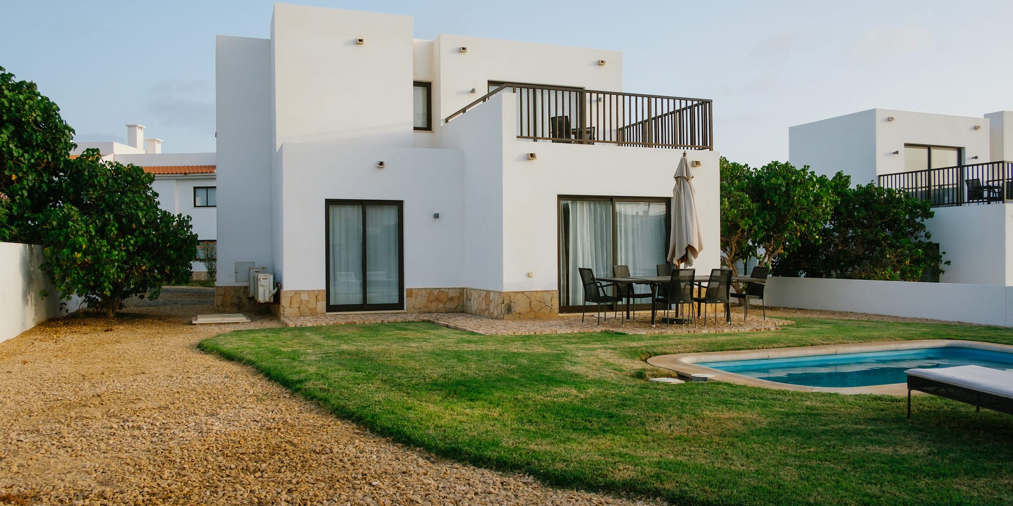 a house with a pool and grass