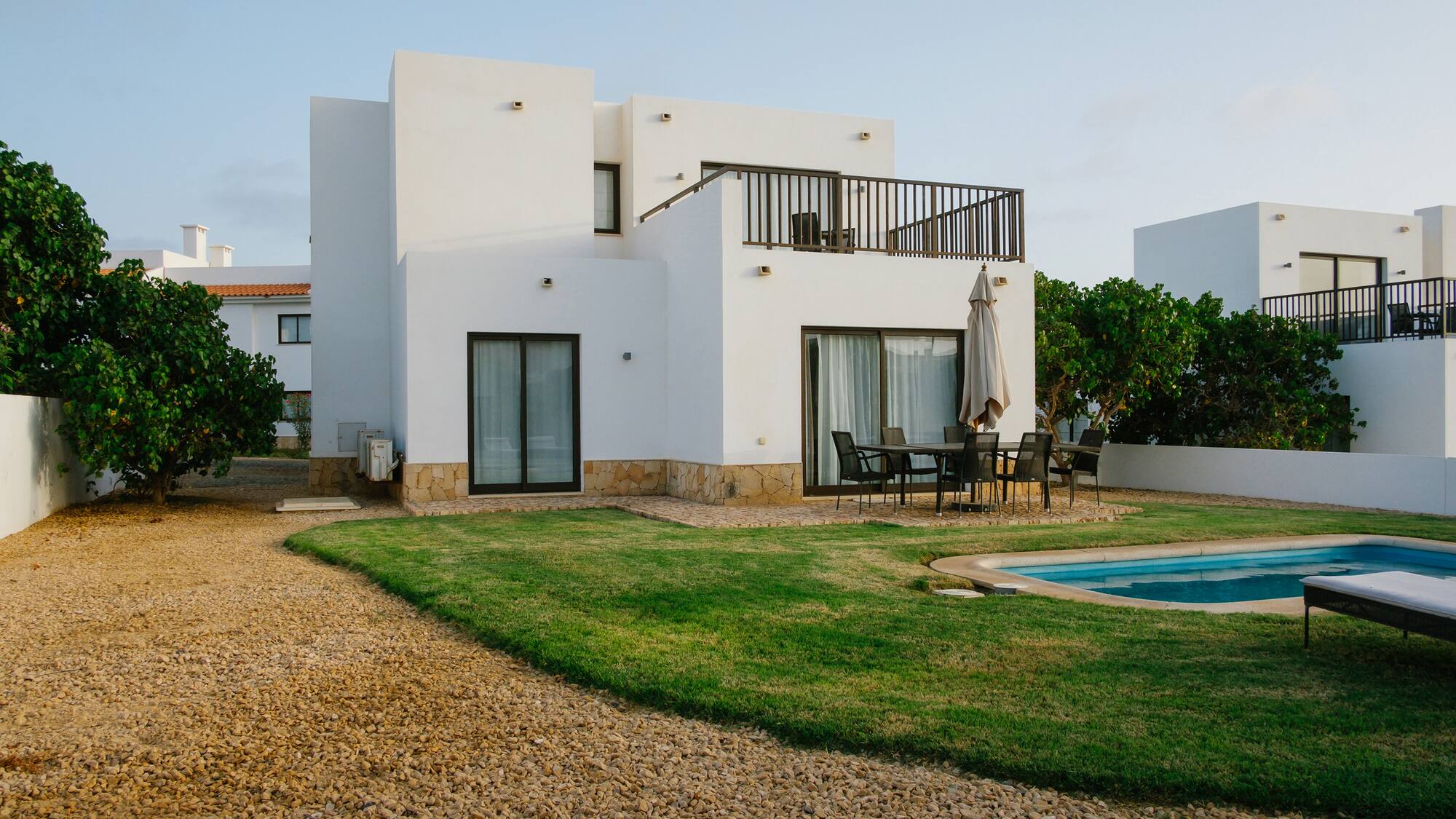 a house with a pool and grass