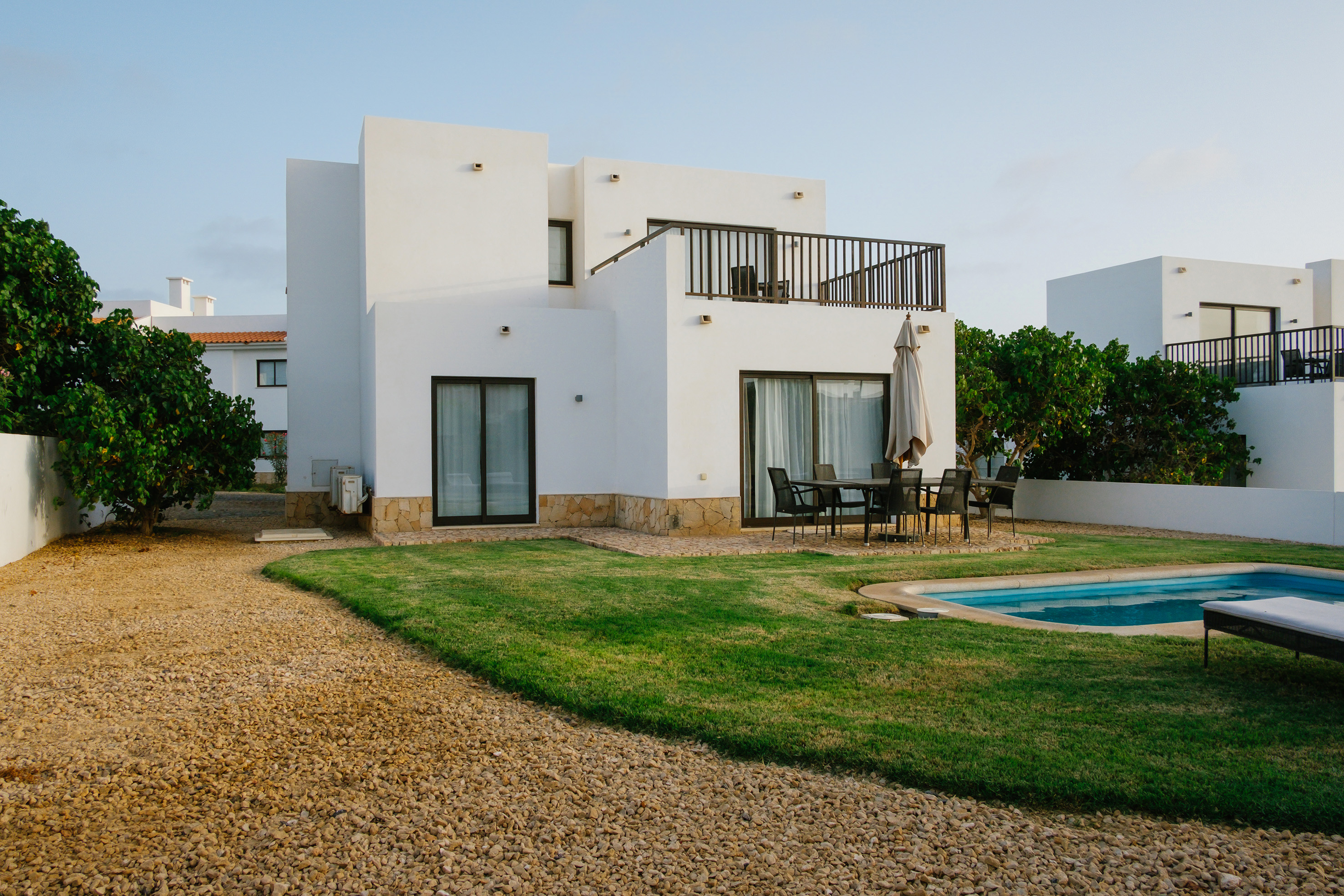 a house with a pool and grass