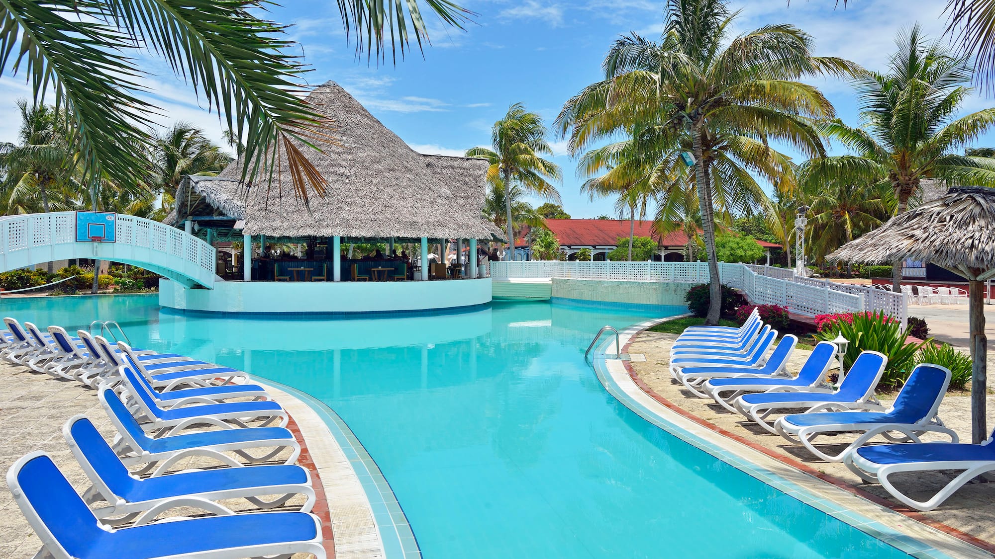 a pool with lounge chairs and a bar