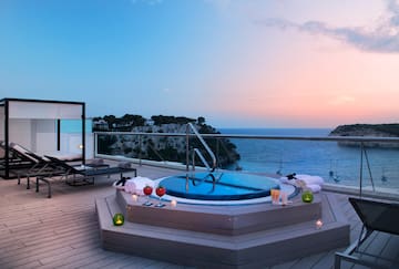 a hot tub on a deck overlooking the ocean